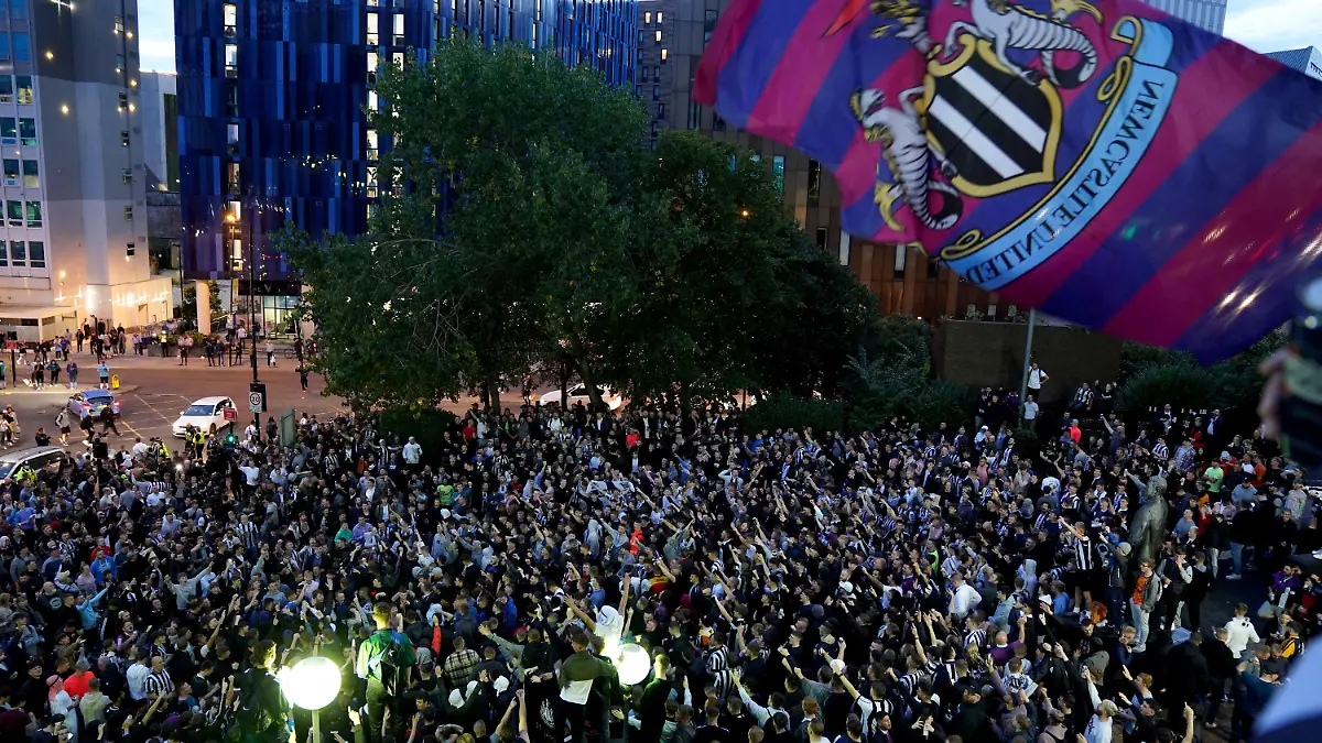 07.10.2021, Großbritannien, Newcastle: Die Fans von Newcastle United feiern vor dem Stadion St. James' Park, nachdem bekannt wurde, dass die von den Saudis geführte Übernahme von Newcastle genehmigt worden ist. Foto: Owen Humphreys/PA Wire/dpa +++ dpa-Bildfunk +++