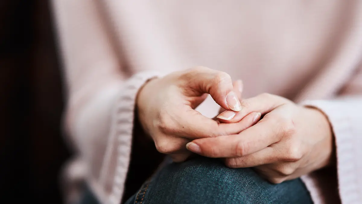 Cropped shot of a woman sitting on a sofa and feeling anxious