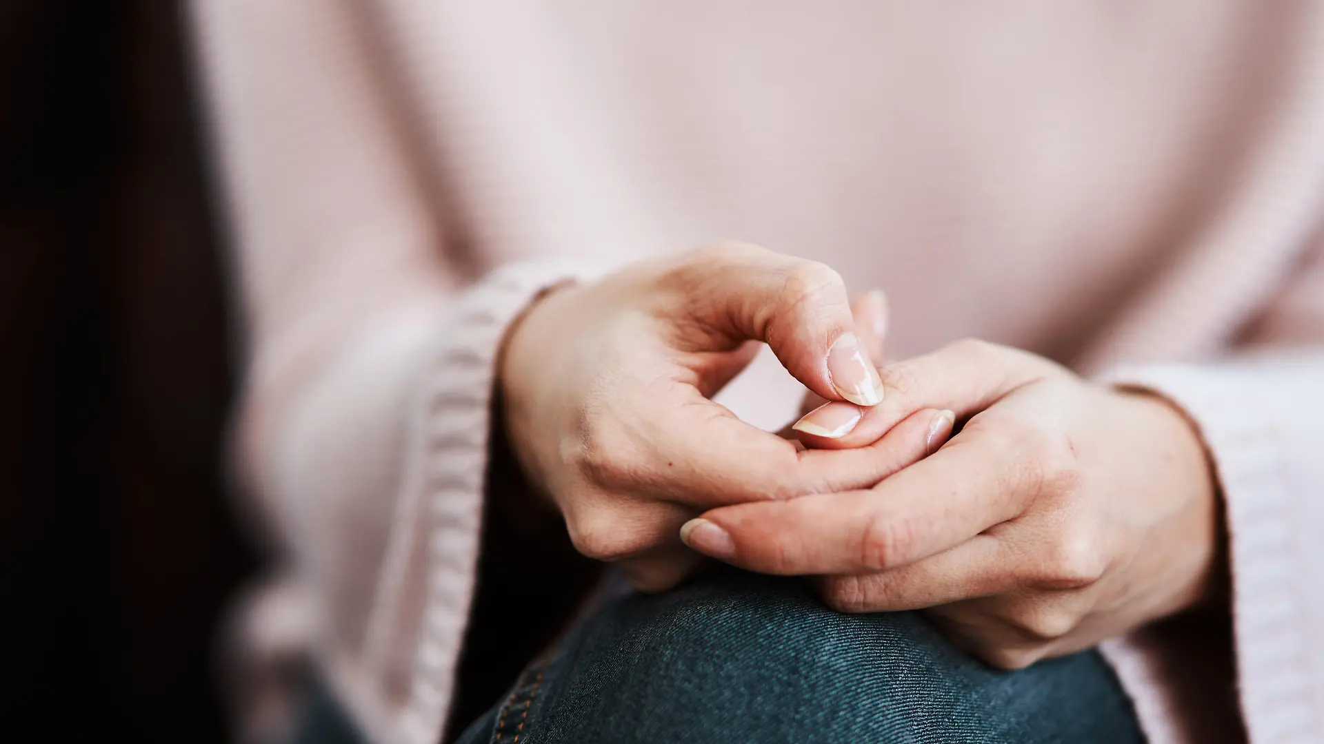 Cropped shot of a woman sitting on a sofa and feeling anxious