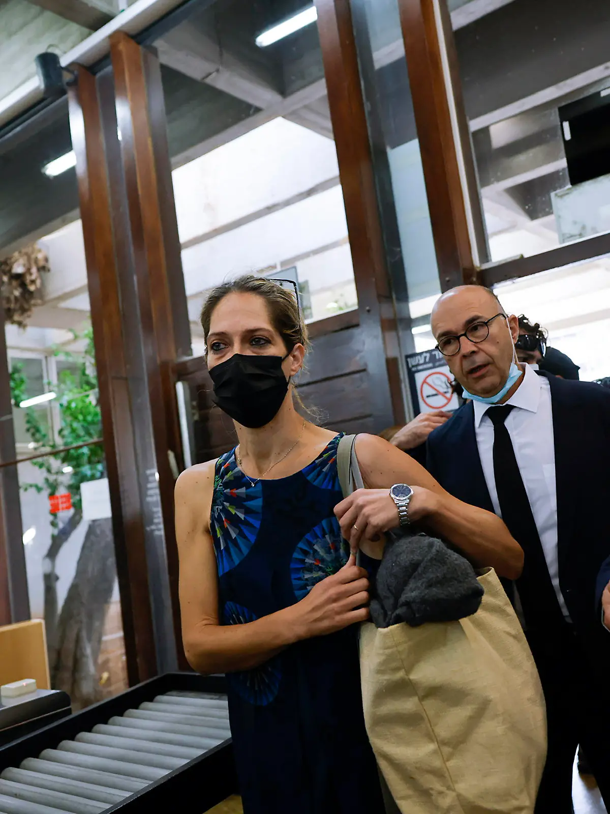 Aya Biran, center, a paternal aunt of Eitan Biran, the boy who survived a cable car crash in Italy that killed his immediate family, arrives to court in Tel Aviv Friday, Oct. 8, 2021. Biran's parents and younger sibling were among 14 killed in May when a cable car slammed into a mountainside in northern Italy. He is now the focus of a custody battle between his maternal grandparents in Israel and his paternal relatives in Italy. (AP Photo/Tsafrir Abayov)