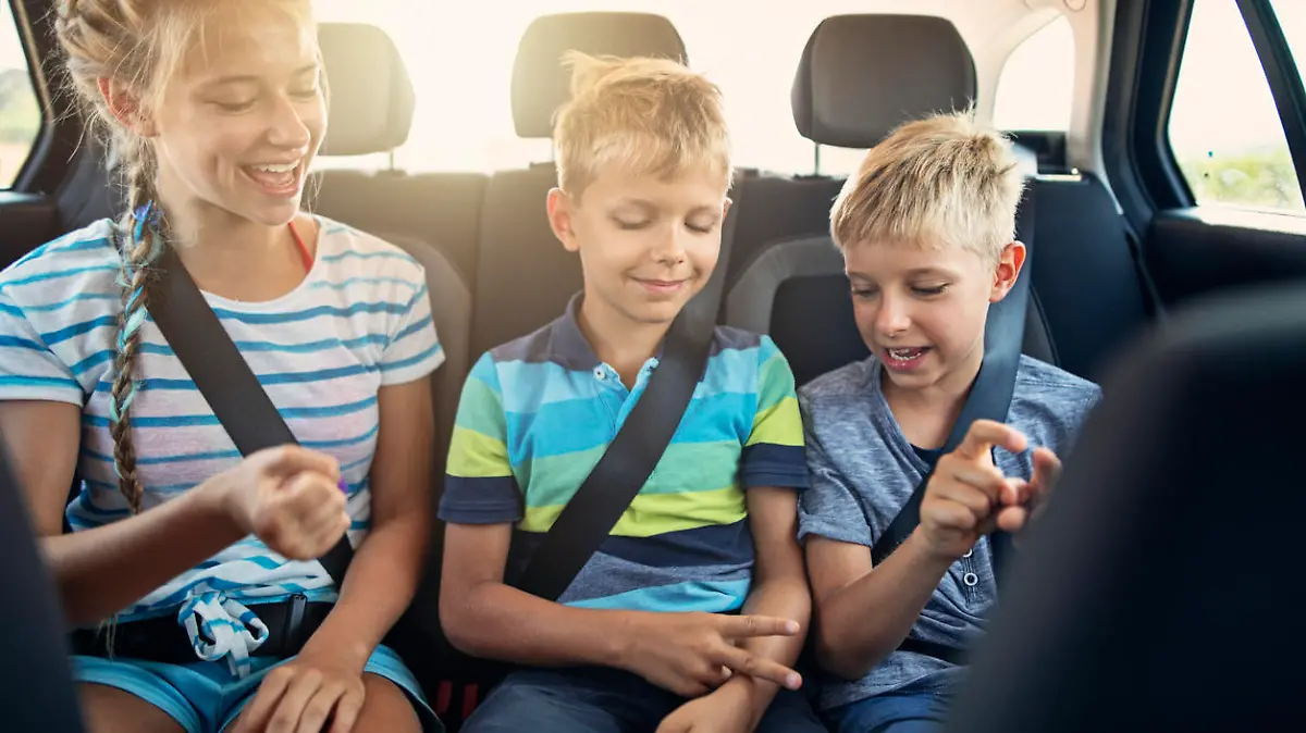 Three kids playing rock paper scissors in car on a road trip. Kids are aged 12 and 9. The kids are laughing and having fun. Sunny summer day.
Nikon D850.