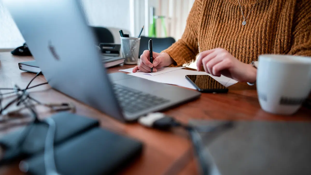ARCHIV - 19.01.2021, Nordrhein-Westfalen, Oberhausen: Eine Frau sitzt mit einem Laptop an einem Tisch im Homeoffice. (zu dpa «Arbeitswelt: Zwischen Homeoffice-Blues und neuen Freiheiten») Foto: Fabian Strauch/dpa +++ dpa-Bildfunk +++