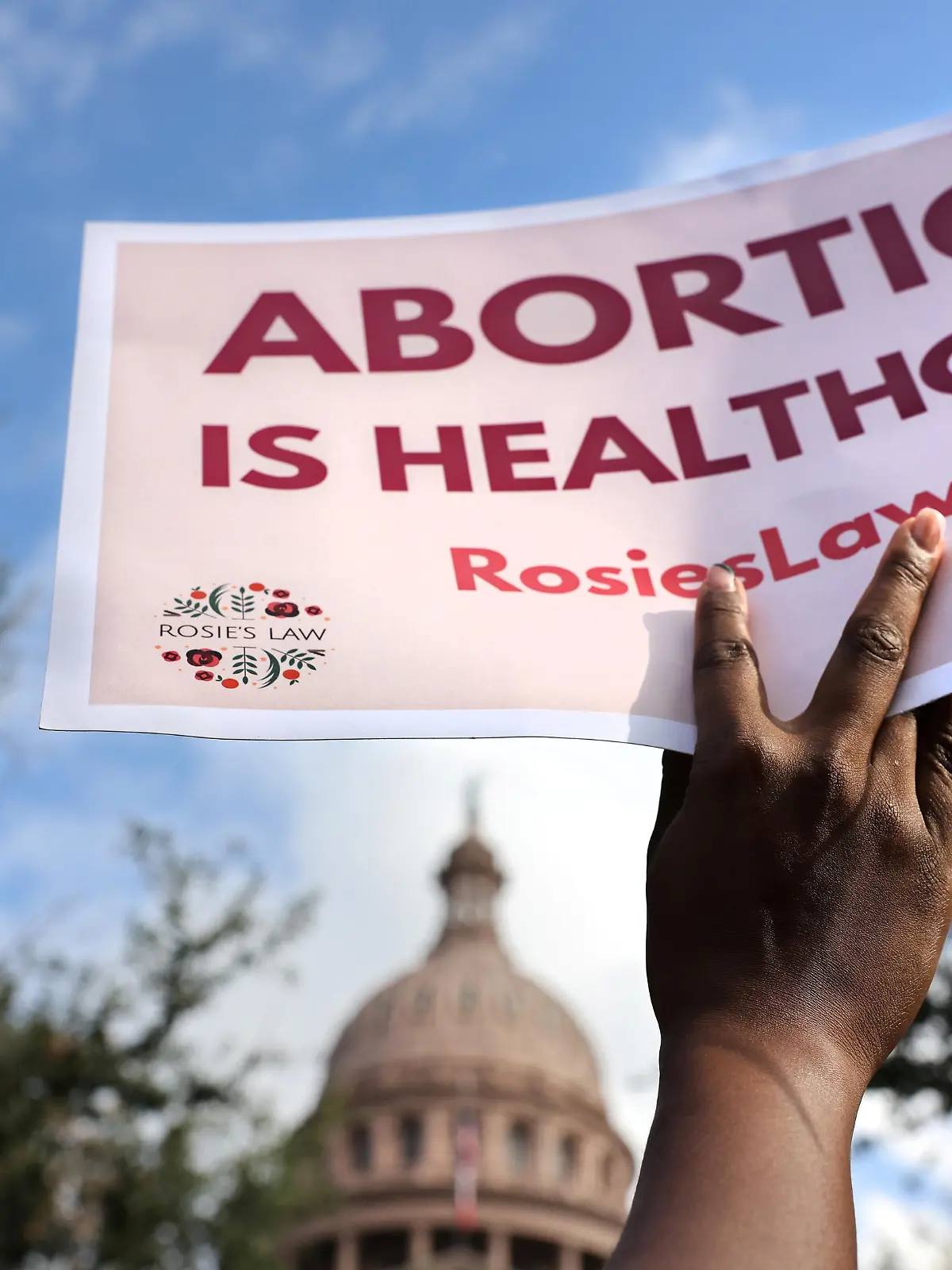 A supporter of reproductive rights holds a sign outside the Texas State Capitol building during the nationwide Women's March, held after Texas rolled out a near-total ban on abortion procedures and access to abortion-inducing medications, in Austin, Texas, U.S. October 2, 2021. Picture taken October 2, 2021. REUTERS/Evelyn Hockstein