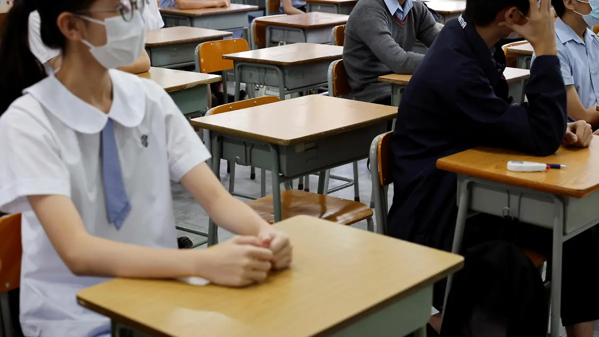 FILE PHOTO: Empty seats are seen inside a classroom of a secondary school at the first day of the new term in Hong Kong, China September 1, 2021. REUTERS/Tyrone Siu/File Photo