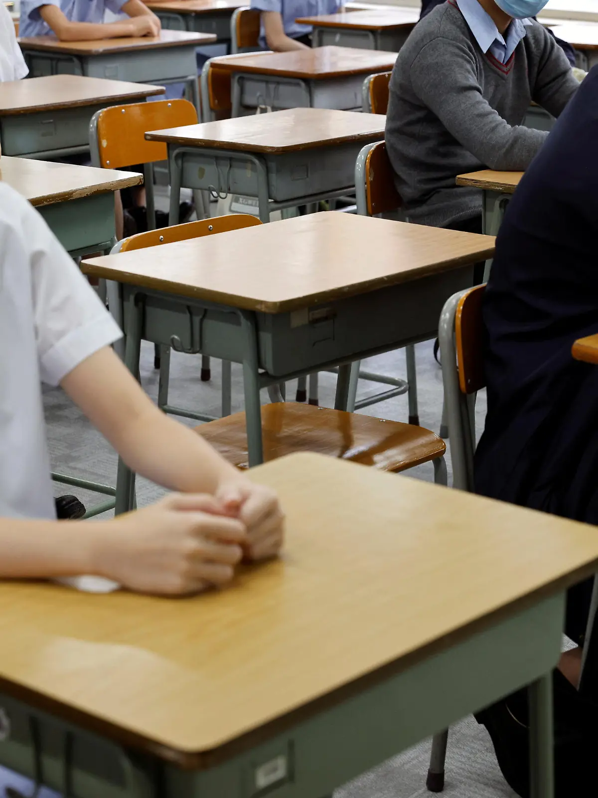 FILE PHOTO: Empty seats are seen inside a classroom of a secondary school at the first day of the new term in Hong Kong, China September 1, 2021. REUTERS/Tyrone Siu/File Photo