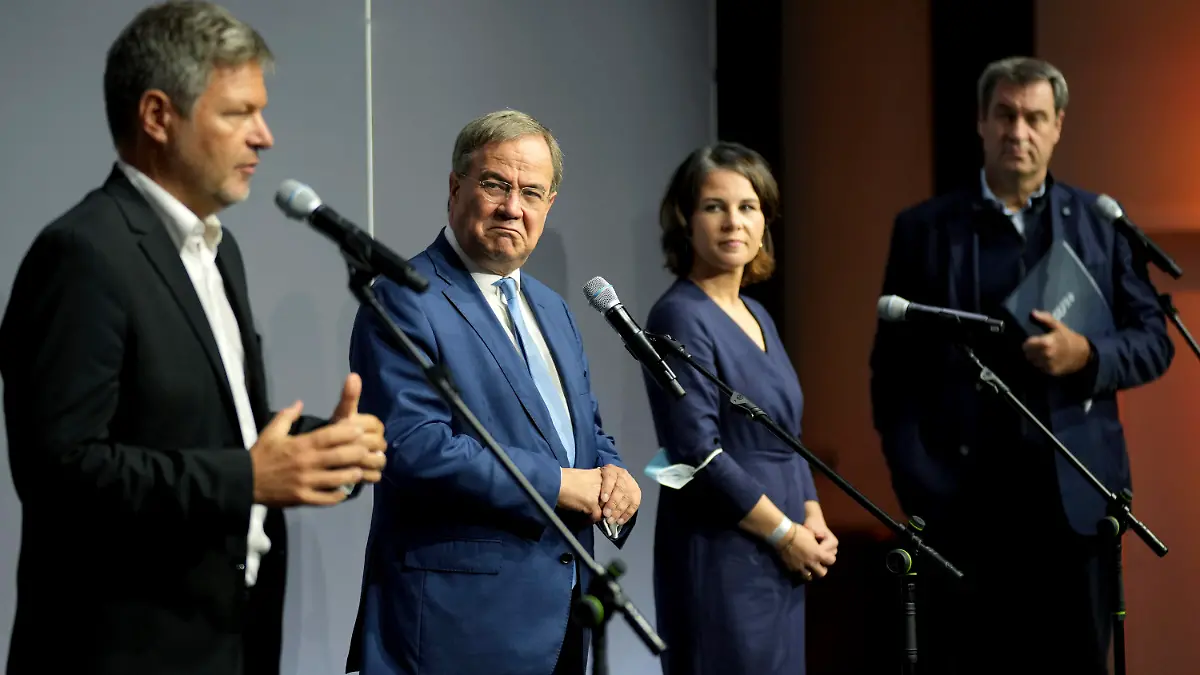 From left, Robert Habeck, co-chairman of the German Green party (Die Gruenen), Armin Laschet, chairman of the German Christian Democratic Party (CDU), Annalena Baerbock, co-chairwoman of the German Green party (Die Gruenen), and Markus Soeder, chairman of the German Christian Social Union (CSU), attend a statement after a meeting in Berlin, Germany, Tuesday, Oct. 5, 2021. A delegation from outgoing Chancellor Angela Merkel's center-right Union bloc met with the environmentalist Greens on Tuesday for exploratory talks on the formation of a new German government. (AP Photo/Michael Sohn)