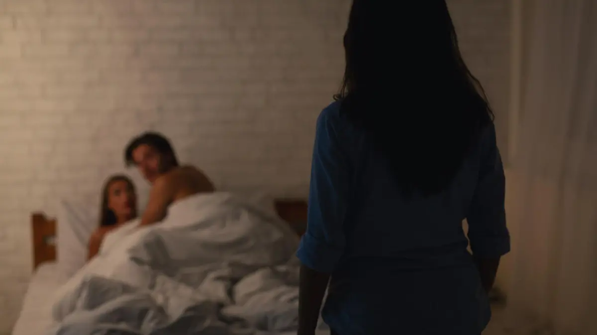 Infidelity Concept. Woman Catching Cheating Boyfriend Making Love With Another Girl In Their Bedroom At Home. Low Light