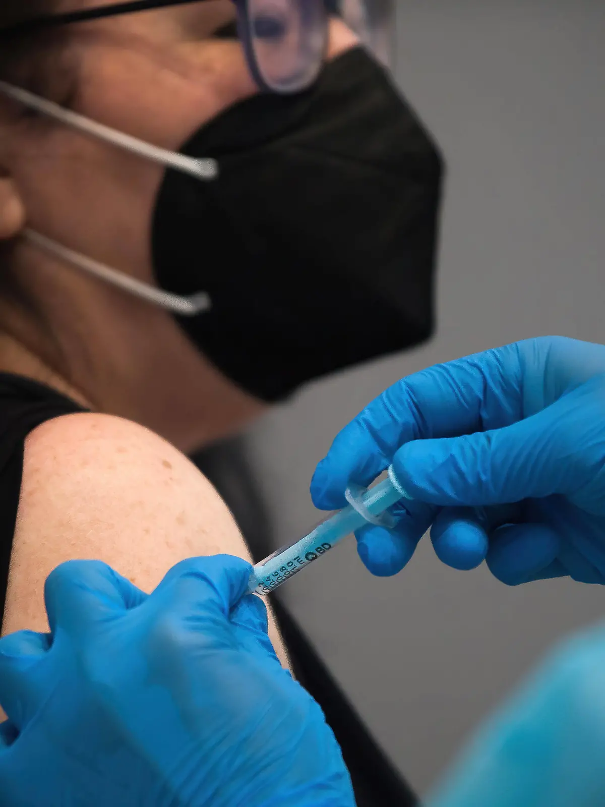 May 5, 2021, Malaga, Spain: A woman wearing a face mask as a precaution against the spread of covid-19 is being vaccinated by a health worker inside a cubicle during a massive vaccination at Fair and Congresses Palace..Health regional authorities have retimed again the vaccination with doses of Pfizer BioNTech inside large and secure places following all protective measures, as part of massive vaccination One million plan after the announcement of Andalusian government to inoculate around 600.000 vaccines during the week. Malaga Spain - ZUMAs197 20210505_zaa_s197_022 Copyright: xJesusxMeridax 