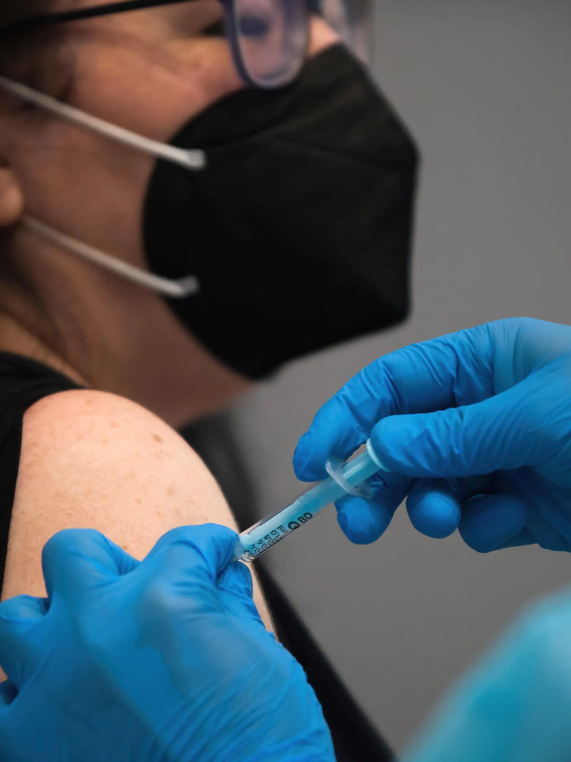 May 5, 2021, Malaga, Spain: A woman wearing a face mask as a precaution against the spread of covid-19 is being vaccinated by a health worker inside a cubicle during a massive vaccination at Fair and Congresses Palace..Health regional authorities have retimed again the vaccination with doses of Pfizer BioNTech inside large and secure places following all protective measures, as part of massive vaccination One million plan after the announcement of Andalusian government to inoculate around 600.000 vaccines during the week. Malaga Spain - ZUMAs197 20210505_zaa_s197_022 Copyright: xJesusxMeridax 