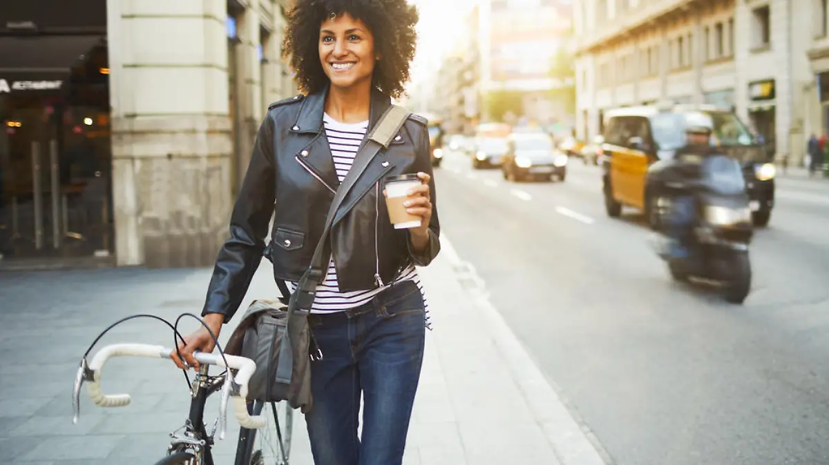 Young hipster woman in the streets of Barcelona commuting. Mixed race model, spanish and Ethiopian.