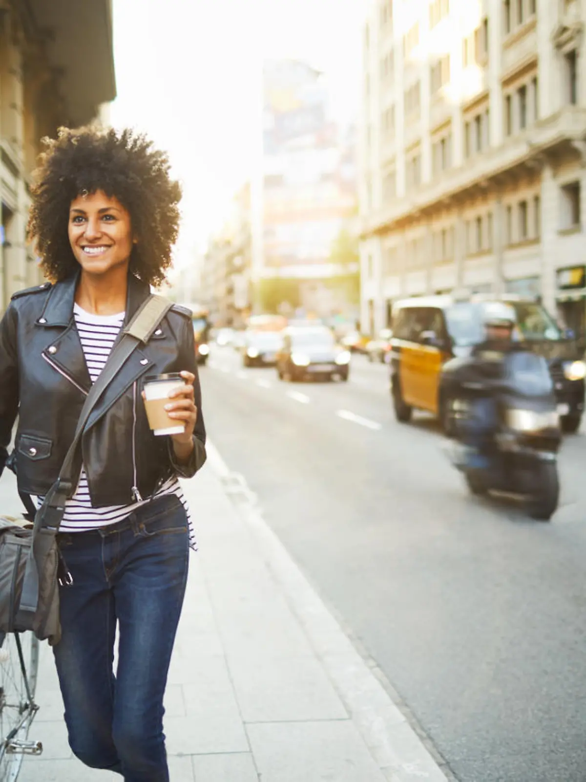 Young hipster woman in the streets of Barcelona commuting. Mixed race model, spanish and Ethiopian.
