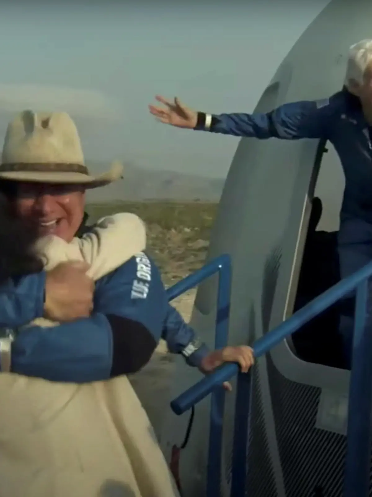 Billionaire businessman Jeff Bezos and pioneering female aviator Wally Funk emerge from their capsule after their flight aboard Blue Origin's New Shepard rocket on the world's first unpiloted suborbital flight near Van Horn, Texas, U.S., July 20, 2021 in a still image from video.  Blue Origin/Handout via REUTERS.     NO RESALES. NO ARCHIVES. THIS IMAGE HAS BEEN SUPPLIED BY A THIRD PARTY.