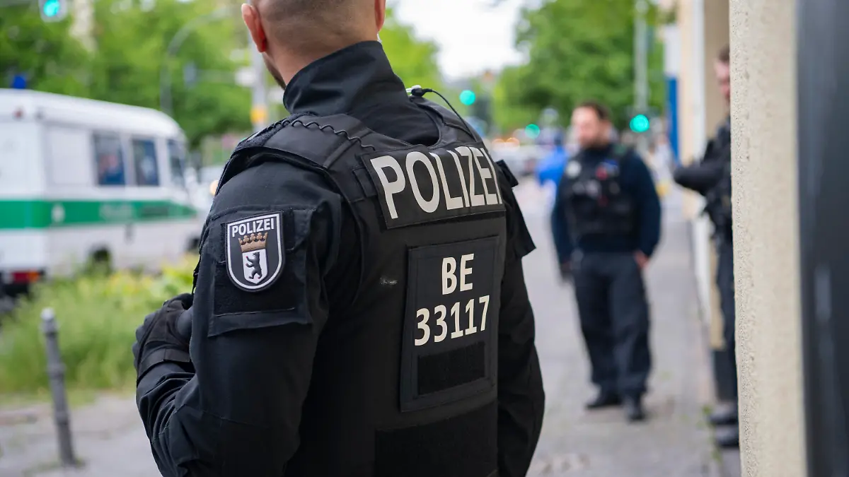 14.05.2020, Berlin: Polizeibeamte stehen auf der Mecklenburgischen Straße. Im Rahmen einer Razzia durchsuchen eine Hundertschaft der Polizei Berlin und das LKA seit dem Morgen mehrere Objekte in Berlin. Es geht um den Verdacht des Drogenhandels und um Waffenbesitz. Laut Polizei richten sich die Durchsuchungsmaßnahmen gegen eine arabischstämmige Großfamilie. Foto: Paul Zinken/dpa-zb-Zentralbild/dpa +++ dpa-Bildfunk +++