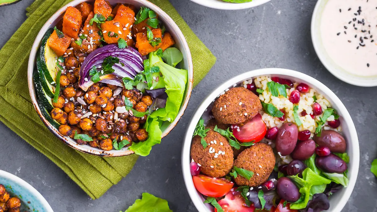 Mixed healthy vegetarian salads with vegetables, sweet potato, falafel, bulgur, avocado, eggs. Assorted buddha bowl salads. Vegetarian food. Healthy lunch/dinner. Salad in bowl. Ingredients for making