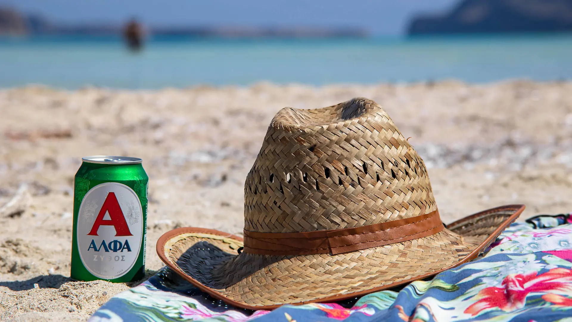 Tourism In Greece - Famous Balos Beach In Crete Island A hat and a beer on a towel on the sand of Balos Beach, the incredible lagoon with the turquoise exotic and tropical water of the Mediterranean sea is located in Chania region in Crete Island. Balos is one of the most visited beaches in Crete and popular for visitors around the world. Crystal clear water, the lagoon, rocky steep mountains, a beach bar providing umbrellas and shadow with beverages and a pirate island are located at the same region that is accessible by a 20 min trek or boat. Greece is trying to boost its tourism and give privileges to vaccinated against Covid-19 Coronavirus pandemic international tourists and locals, as the country is heavily depended from the tourism in PUBLICATIONxNOTxINxFRA Copyright: xNicolasxEconomoux