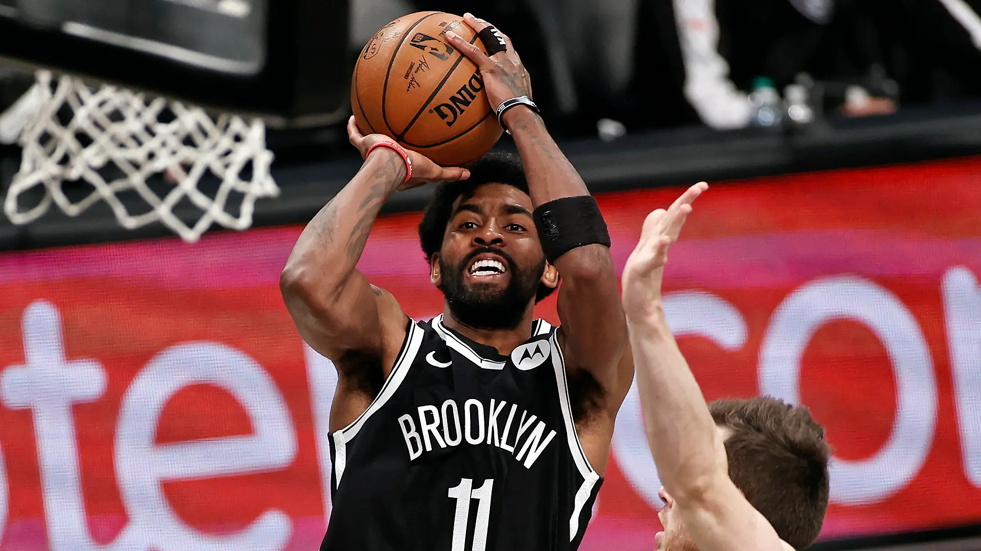 FILE - Brooklyn Nets guard Kyrie Irving (11) shoots against the Milwaukee Bucks during the second half of Game 1 of an NBA basketball second-round playoff series in New York, in this Saturday, June 5, 2021, file photo. Players like Kyrie Irving, who has refused to say if he will be vaccinated against COVID-19, will be subject to testing on all NBA practice, travel and game days this season. Fully vaccinated players will not. (AP Photo/Adam Hunger, File)