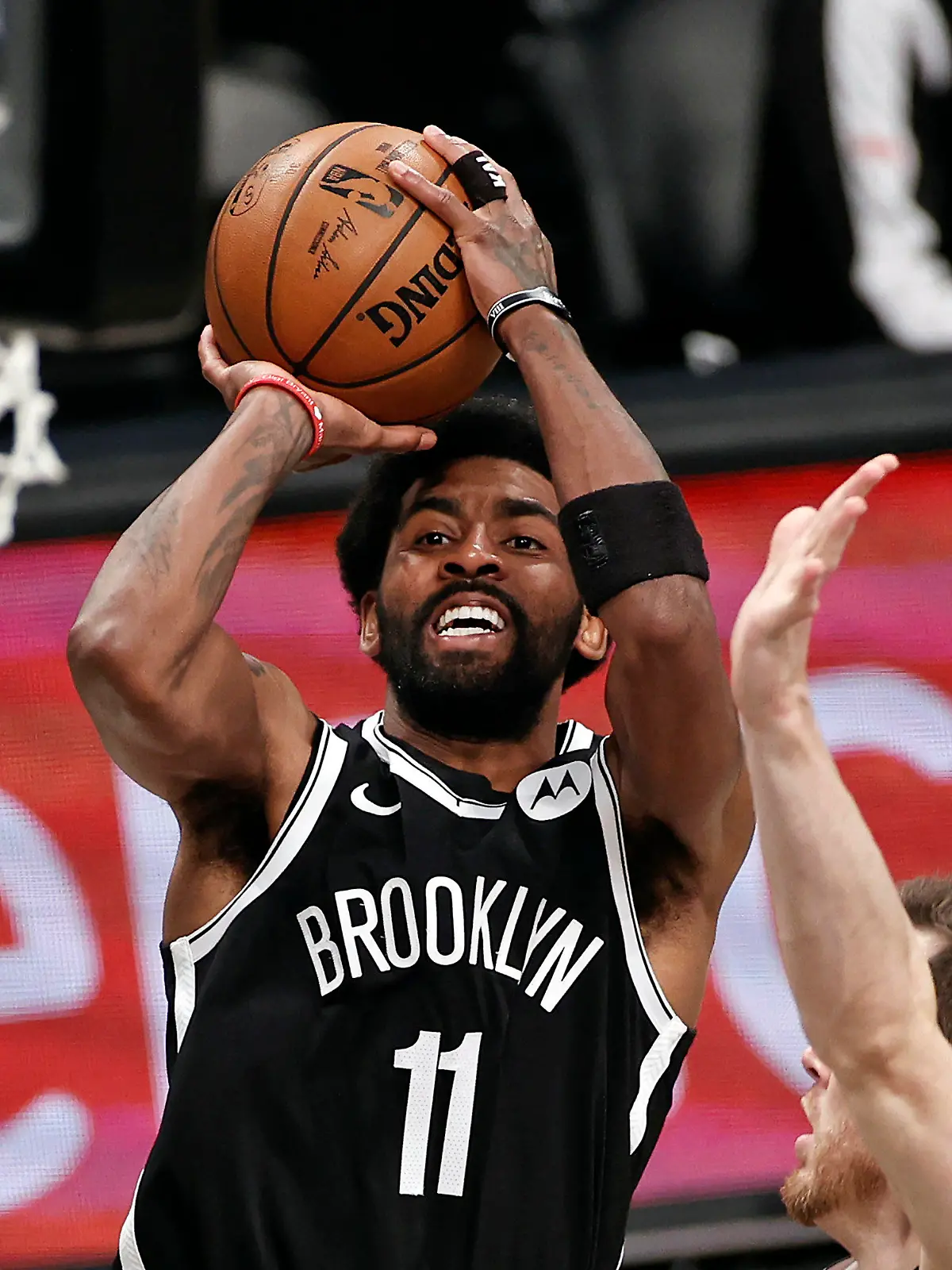 FILE - Brooklyn Nets guard Kyrie Irving (11) shoots against the Milwaukee Bucks during the second half of Game 1 of an NBA basketball second-round playoff series in New York, in this Saturday, June 5, 2021, file photo. Players like Kyrie Irving, who has refused to say if he will be vaccinated against COVID-19, will be subject to testing on all NBA practice, travel and game days this season. Fully vaccinated players will not. (AP Photo/Adam Hunger, File)
