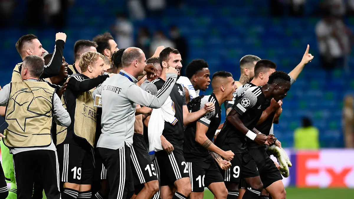 Sheriff's players celebrate at the end of the Champions League group D soccer match between Real Madrid and Sheriff, Tiraspol at the Bernabeu stadium in Madrid, Spain, Tuesday, Sept. 28, 2021. (AP Photo/Jose Breton)