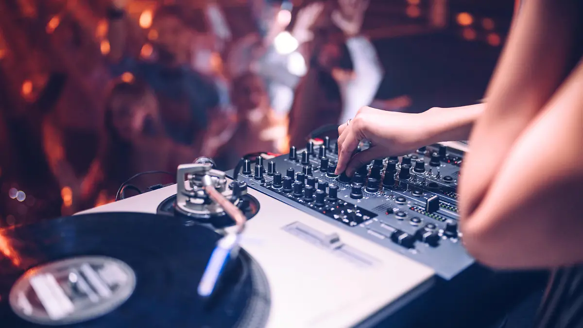 Cropped shot of a DJ playing music at the club