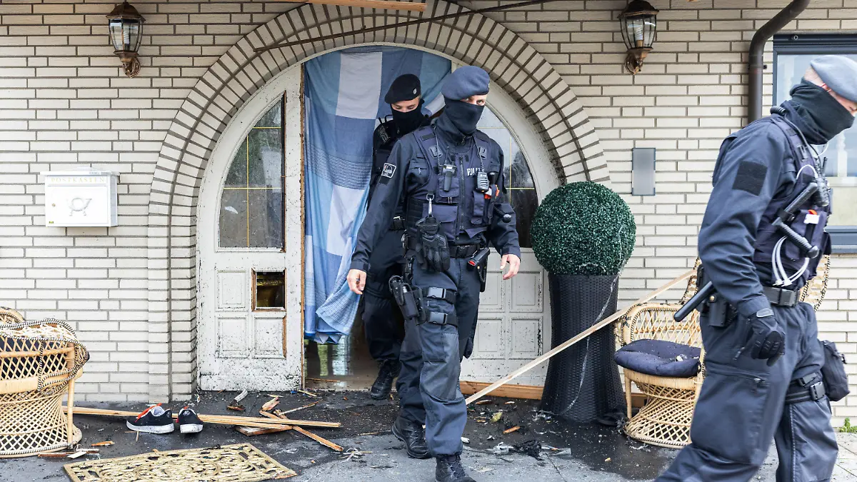 dpatopbilder - 08.06.2021, Nordrhein-Westfalen, Leverkusen: Polizisten verlassen eine Villa. Bei Ermittlungen gegen Clankriminalität durchsuchen derzeit Spezialkräfte der Polizei rund 30 Objekte in Nordrhein-Westfalen. (ACHTUNG: Namensschild an Haustür wurde aus rechtlichen Gründen gepixelt!) Foto: Marcel Kusch/dpa +++ dpa-Bildfunk +++