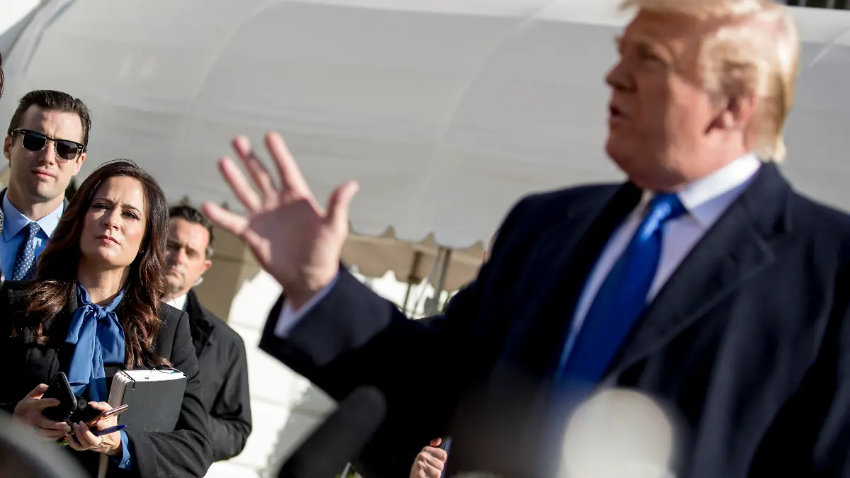 White House press secretary Stephanie Grisham listens as President Donald Trump, speaks to reporters on the South Lawn of the White House in Washington, Friday, Nov. 8, 2019, before boarding Marine One for a short trip to Andrews Air Force Base, Md. and then on to Georgia to meet with supporters. (AP Photo/Andrew Harnik)