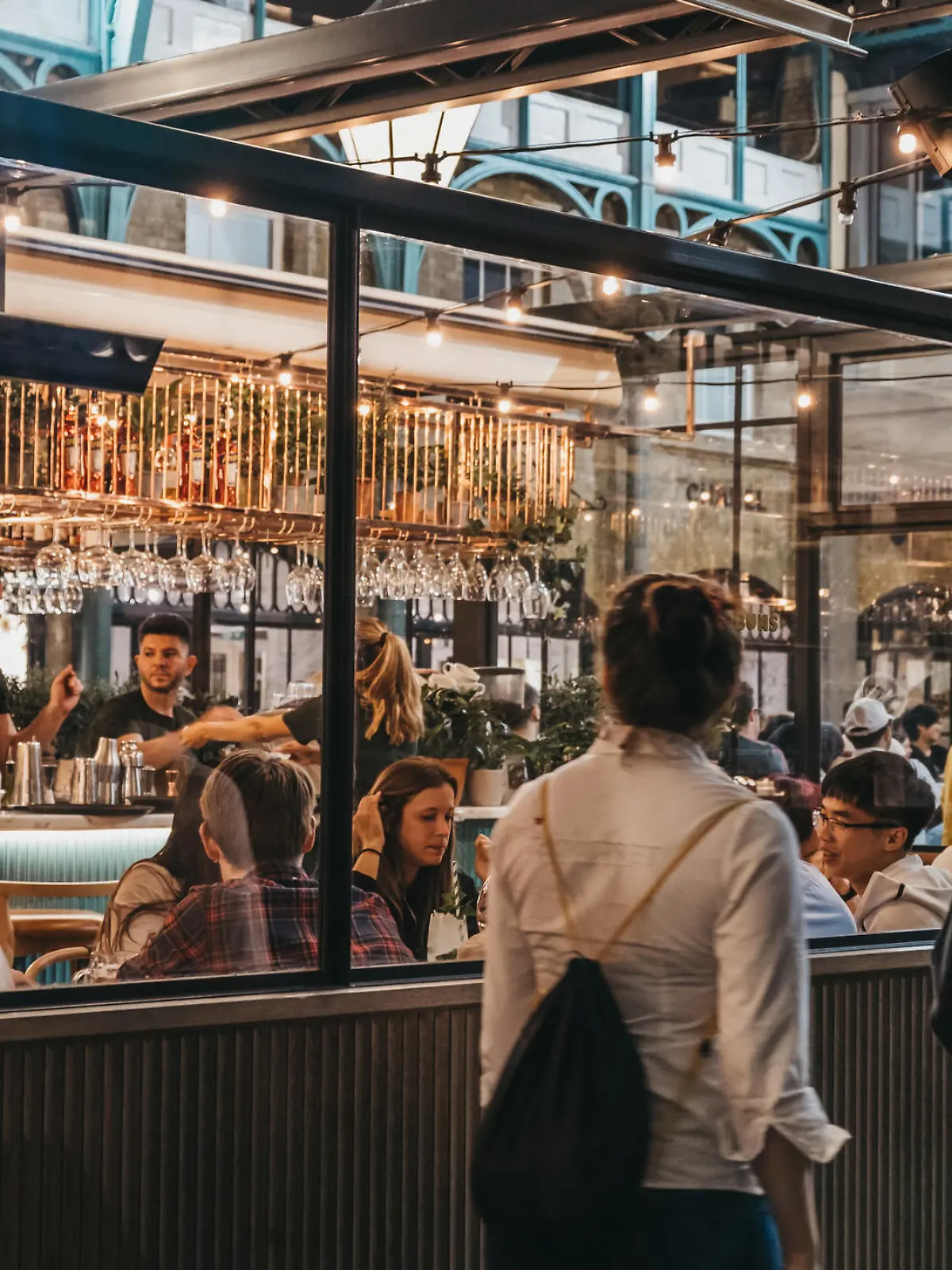 London, UK - August 31, 2019: Women walking past the windows of Buns and Buns restaurant in Covent Garden Market, one of the most popular tourist sites in London, UK.