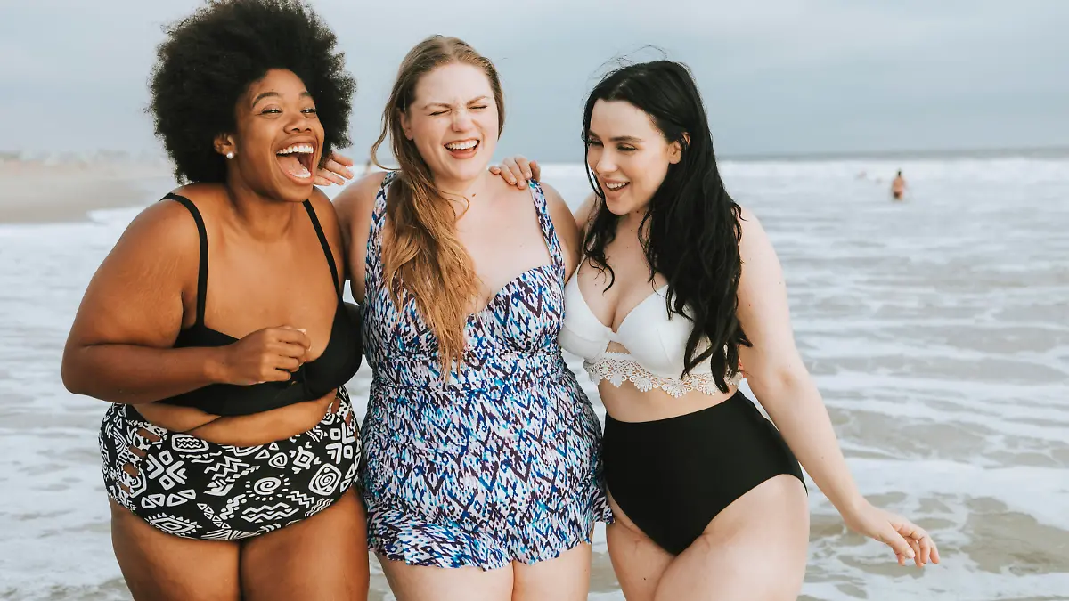 Cheerful plus size women enjoying the beach