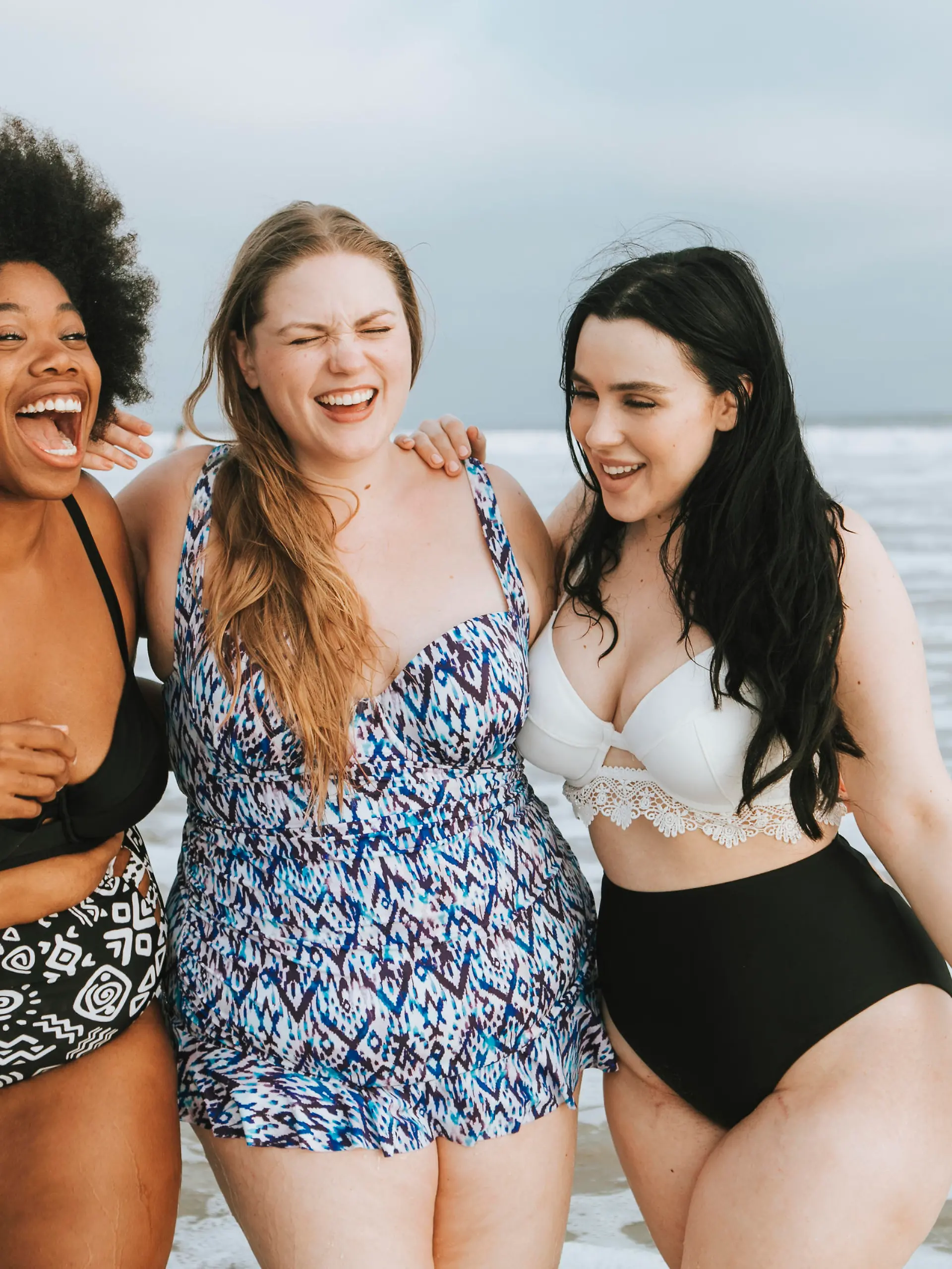 Cheerful plus size women enjoying the beach