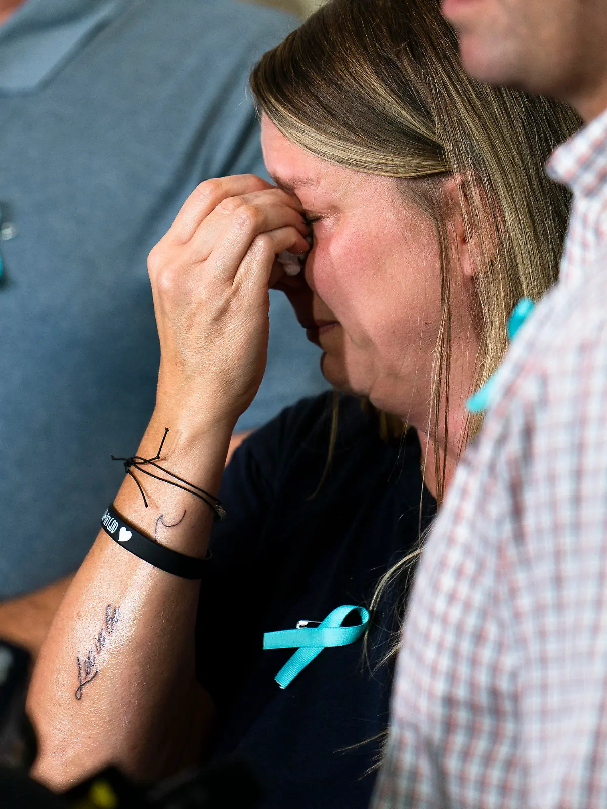Nicole Schmidt, mother of Gabby Petito, whose death on a cross-country trip has sparked a manhunt for her boyfriend Brian Laundrie, wipes tears from her eyes during a news conference, Tuesday, Sept. 28, 2021, in Bohemia, N.Y. Schmidt, along with Petito's father and two step-parents, were recently tattooed in memory of their child with the words, "Let it be." (AP Photo/John Minchillo)