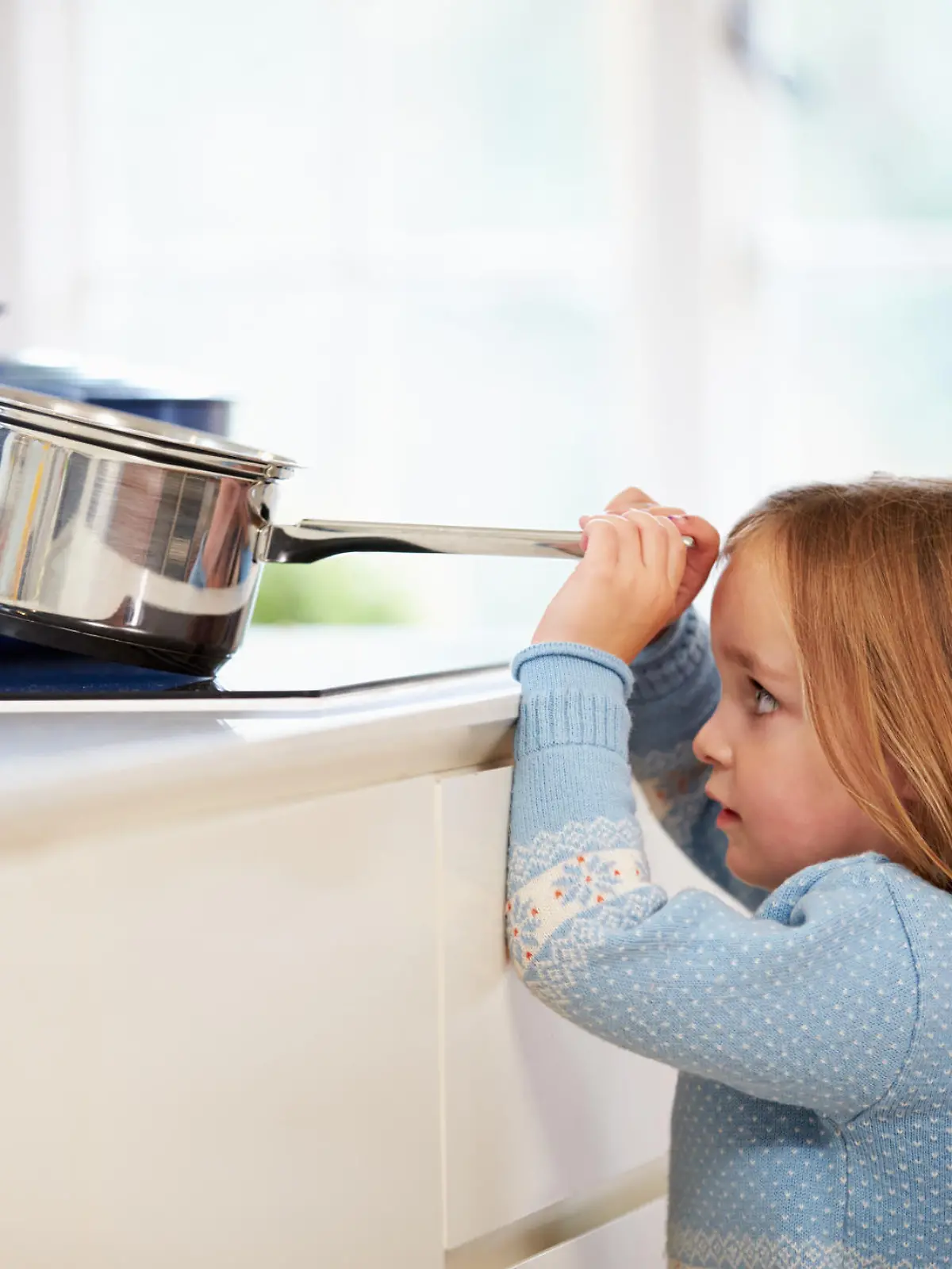 Young Girl Risking Accident With Pan In Brightly Lit Kitchen