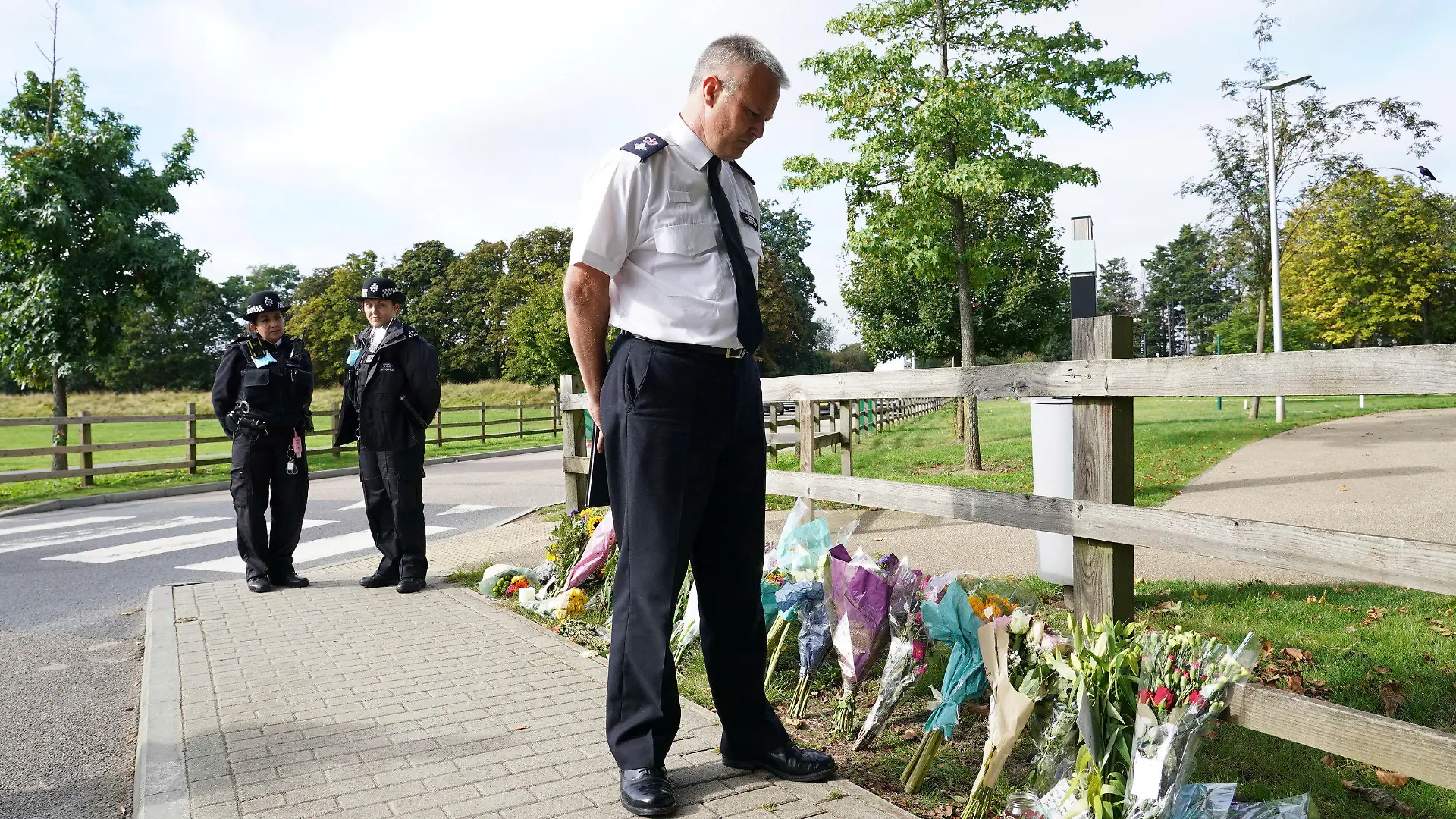 Chief Superintendent Trevor Lawry stands by the floral tributes at Cator Park in Kidbrooke, near to the area where the body of Sabina Nessa was found, in London, Thursday, Sept. 23, 2021. British police investigating the killing of a 28-year-old woman in London say they are probing whether she was attacked by a stranger. It's a case that sparked new concerns for the safety of women walking the capital’s streets. Police called for information over the murder of a primary school teacher Sabina Nessa on Sept.17 in southeast London. Detectives believe she was attacked during what would have been a five-minute walk through a local park on her way to meet a friend at the pub. The case came just a few months after the abduction, rape and murder of 33-year-old Sarah Everard in south London by a serving police officer. London Mayor Sadiq Khan described the violence against women as a national “epidemic.” (Ian West/PA via AP)