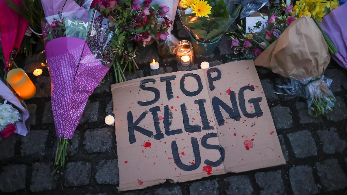 A sign is seen at a memorial site in Clapham Common Bandstand, following the kidnap and murder of Sarah Everard, in London, Britain March 13, 2021. REUTERS/Hannah McKay