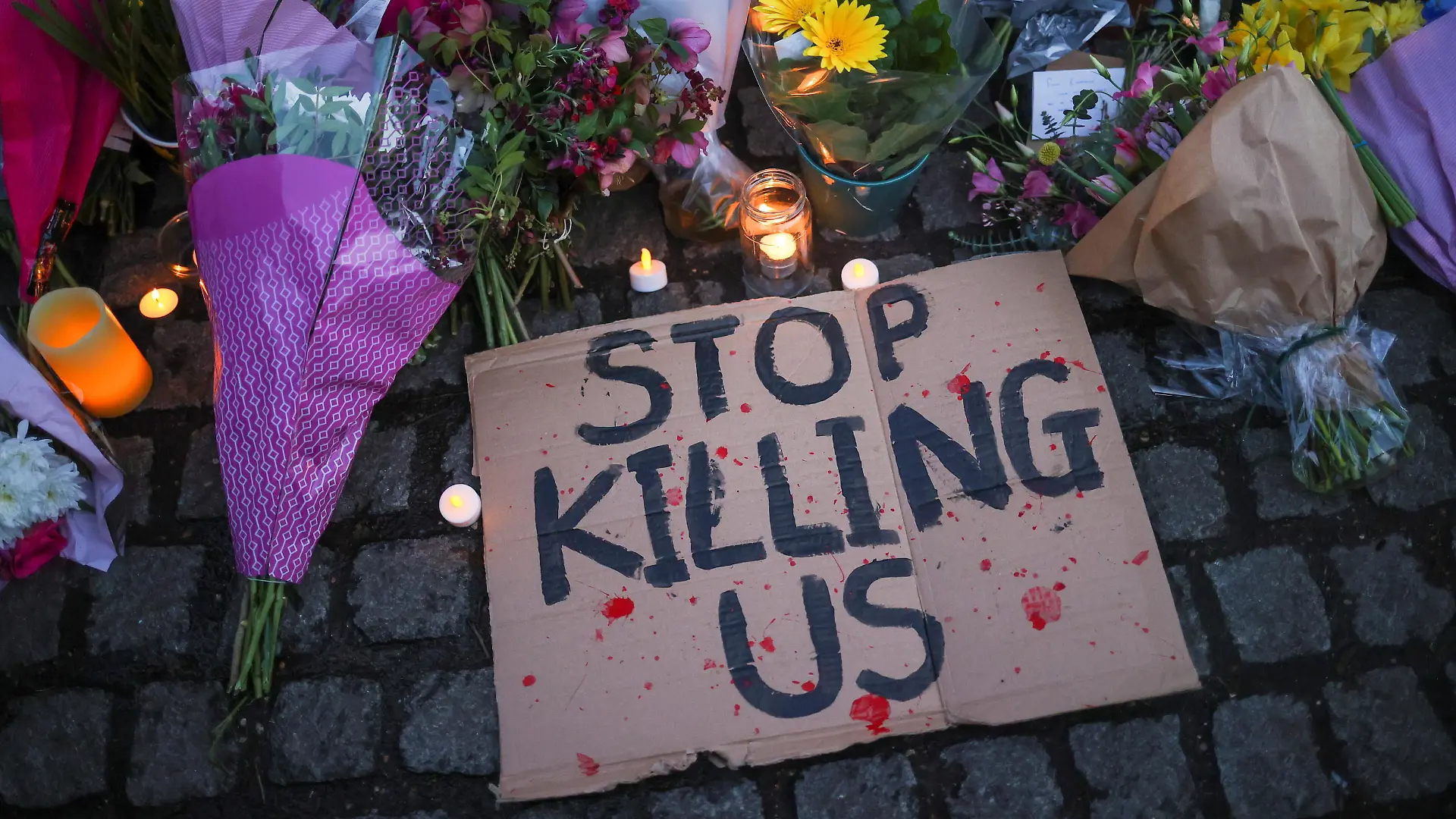A sign is seen at a memorial site in Clapham Common Bandstand, following the kidnap and murder of Sarah Everard, in London, Britain March 13, 2021. REUTERS/Hannah McKay