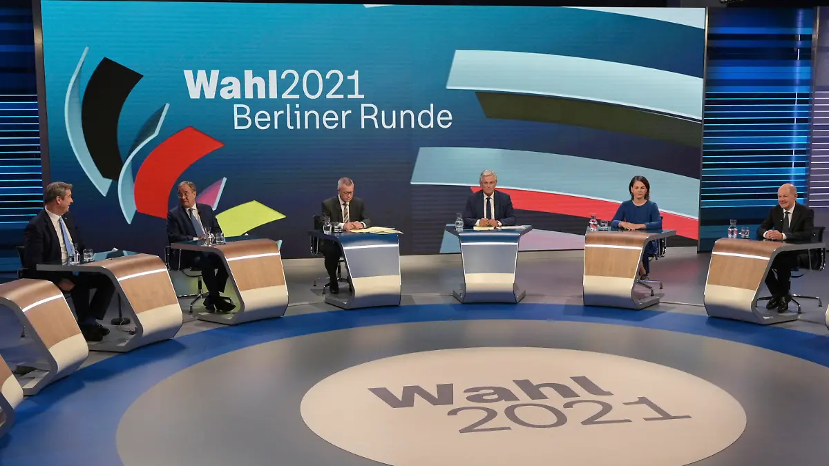 From left: CSU leader Markus Soeder, Armin Laschet of the CDU, the CDU/CSU's candidate for chancellor, moderators Rainald Becker and Peter Frey, Annalena Baerbock, candidate for chancellor of the Green Party, Olaf Scholz, candidate for chancellor of the SPD, prepare to talk about the Bundestag election in an election studio of ZDF at the "Berliner Runde" Sunday Sept. 2021 in Berlin. Projections show Germany’s center-left Social Democrats locked in a very close race with outgoing German Chancellor Angela Merkel’s center-right bloc, which is heading toward its worst-ever result in the country’s parliamentary election. (Sebastian Gollnow/Pool via AP)