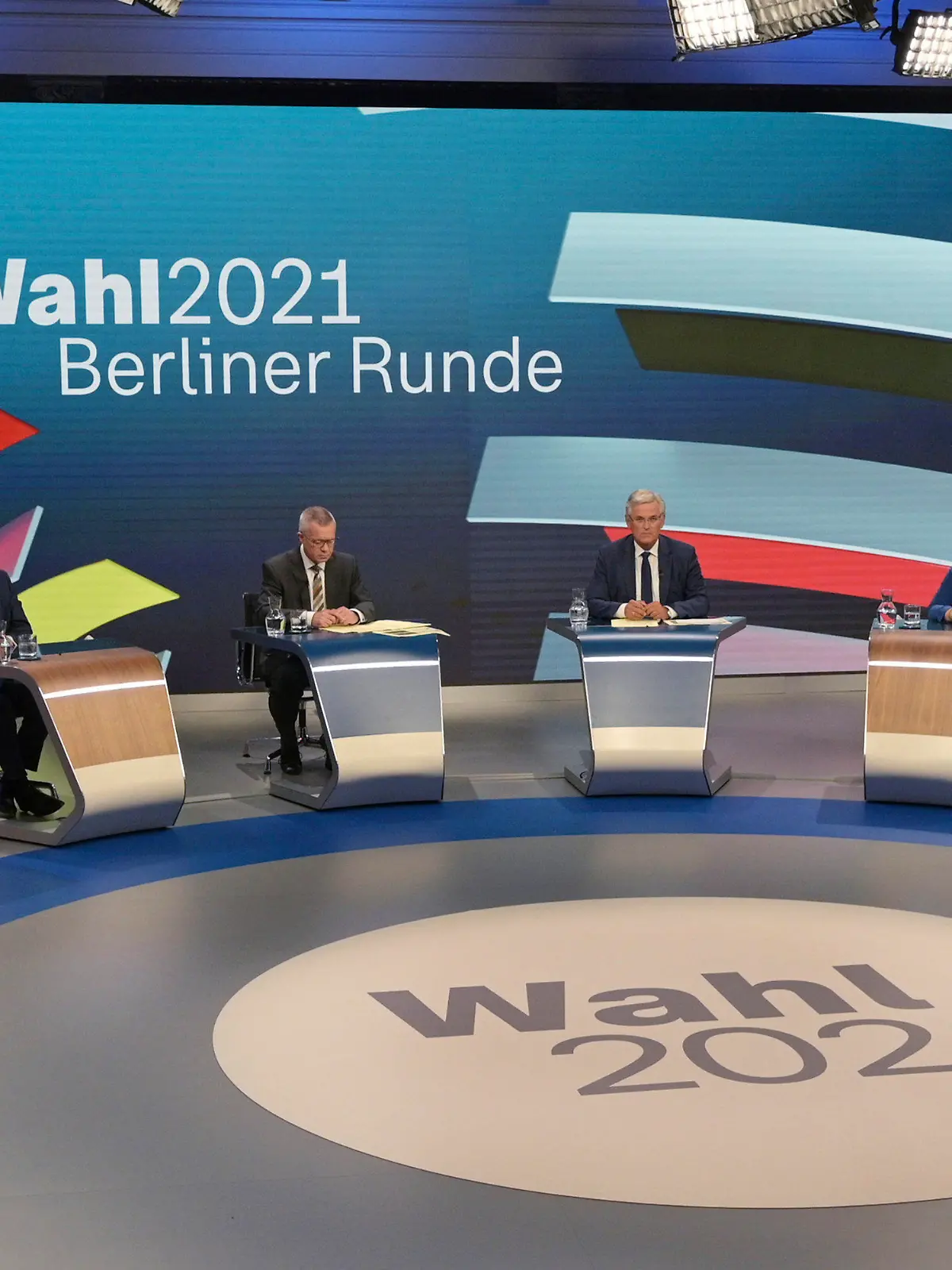 From left: CSU leader Markus Soeder, Armin Laschet of the CDU, the CDU/CSU's candidate for chancellor, moderators Rainald Becker and Peter Frey, Annalena Baerbock, candidate for chancellor of the Green Party, Olaf Scholz, candidate for chancellor of the SPD, prepare to talk about the Bundestag election in an election studio of ZDF at the "Berliner Runde" Sunday Sept. 2021 in Berlin. Projections show Germany’s center-left Social Democrats locked in a very close race with outgoing German Chancellor Angela Merkel’s center-right bloc, which is heading toward its worst-ever result in the country’s parliamentary election. (Sebastian Gollnow/Pool via AP)