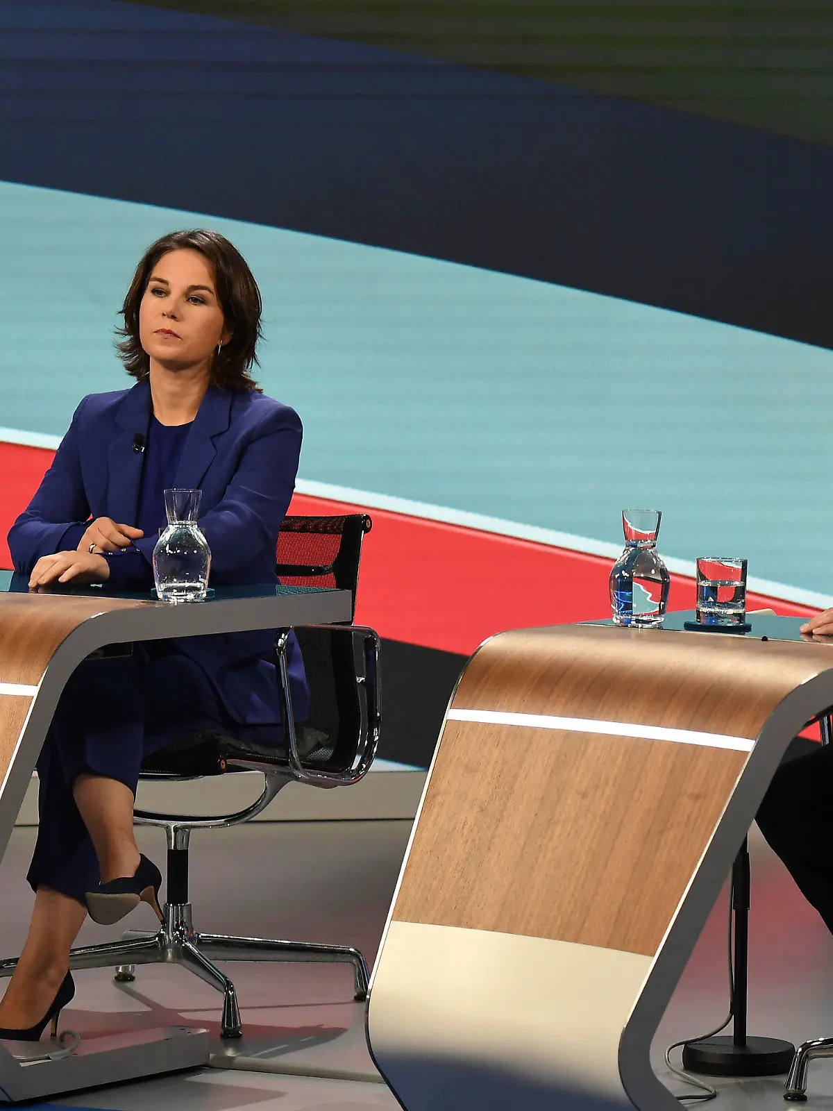 Candidates for the upcoming German election attend a final televised debate in Berlin, Thursday Sept. 23, 2021, ahead of the election on Sunday. Annalena Baerbock, Green Party co-leader, left, and Olaf Scholz, Finance Minister and SPD candidate. (Tobias Schwarz/Pool via AP)