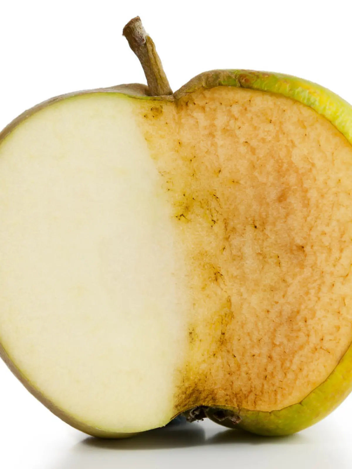 Apple sliced in half. Half fresh and half decayed on white background