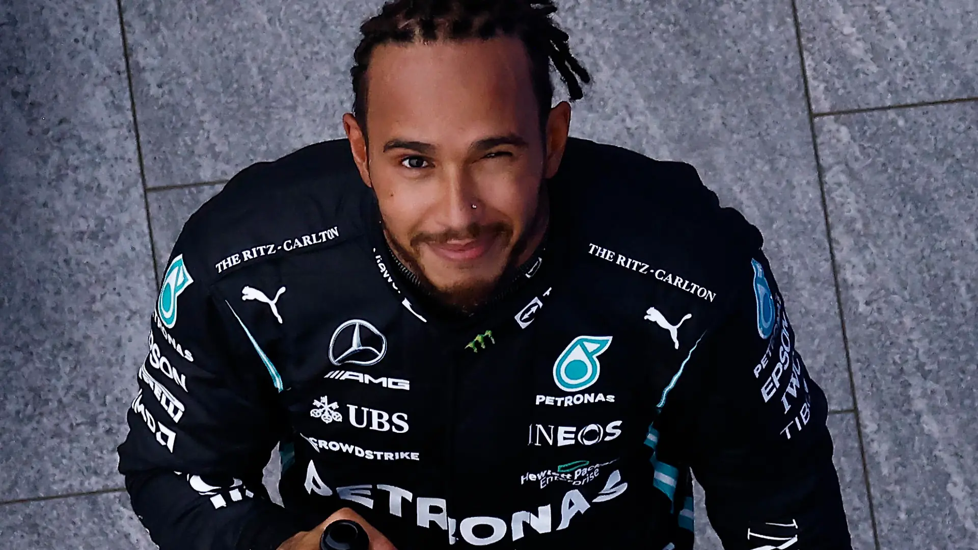 Formula One F1 - Russian Grand Prix - Sochi Autodrom, Sochi, Russia - September 26, 2021 Mercedes' Lewis Hamilton celebrates with champagne on the podium after winning the race Pool via REUTERS/Maxim Shemetov