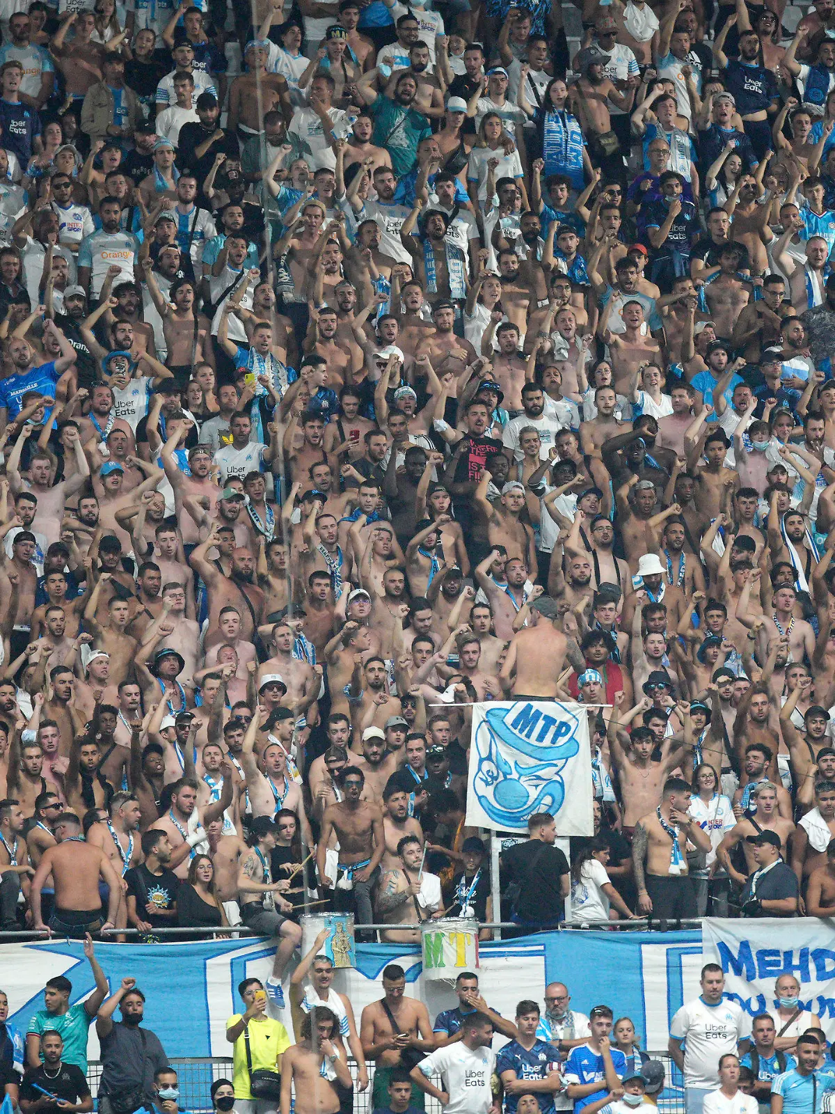 Soccer fans prior to the French League One soccer match between Marseille and Saint-Etienne at the Velodrome stadium in Marseille, southern France, Saturday, Aug. 28, 2021. (AP Photo/Daniel Cole)