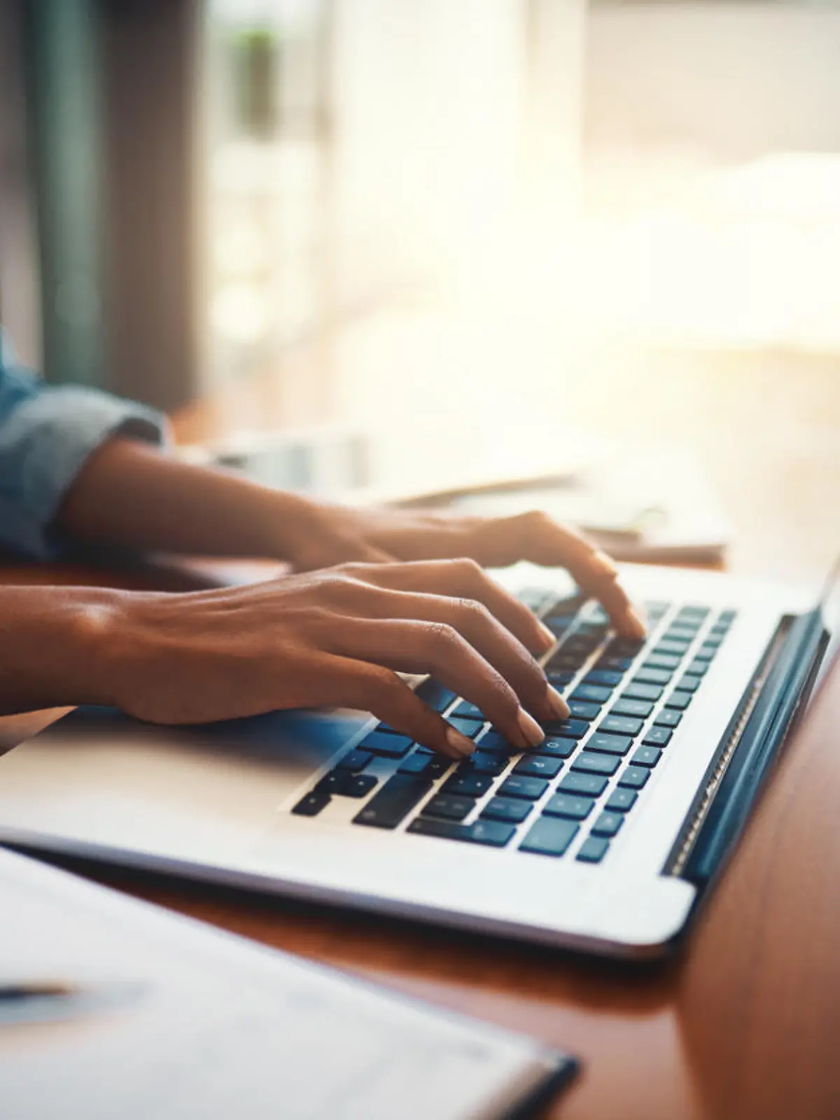 Closeup shot of an unrecognizable woman using a laptop while working from home