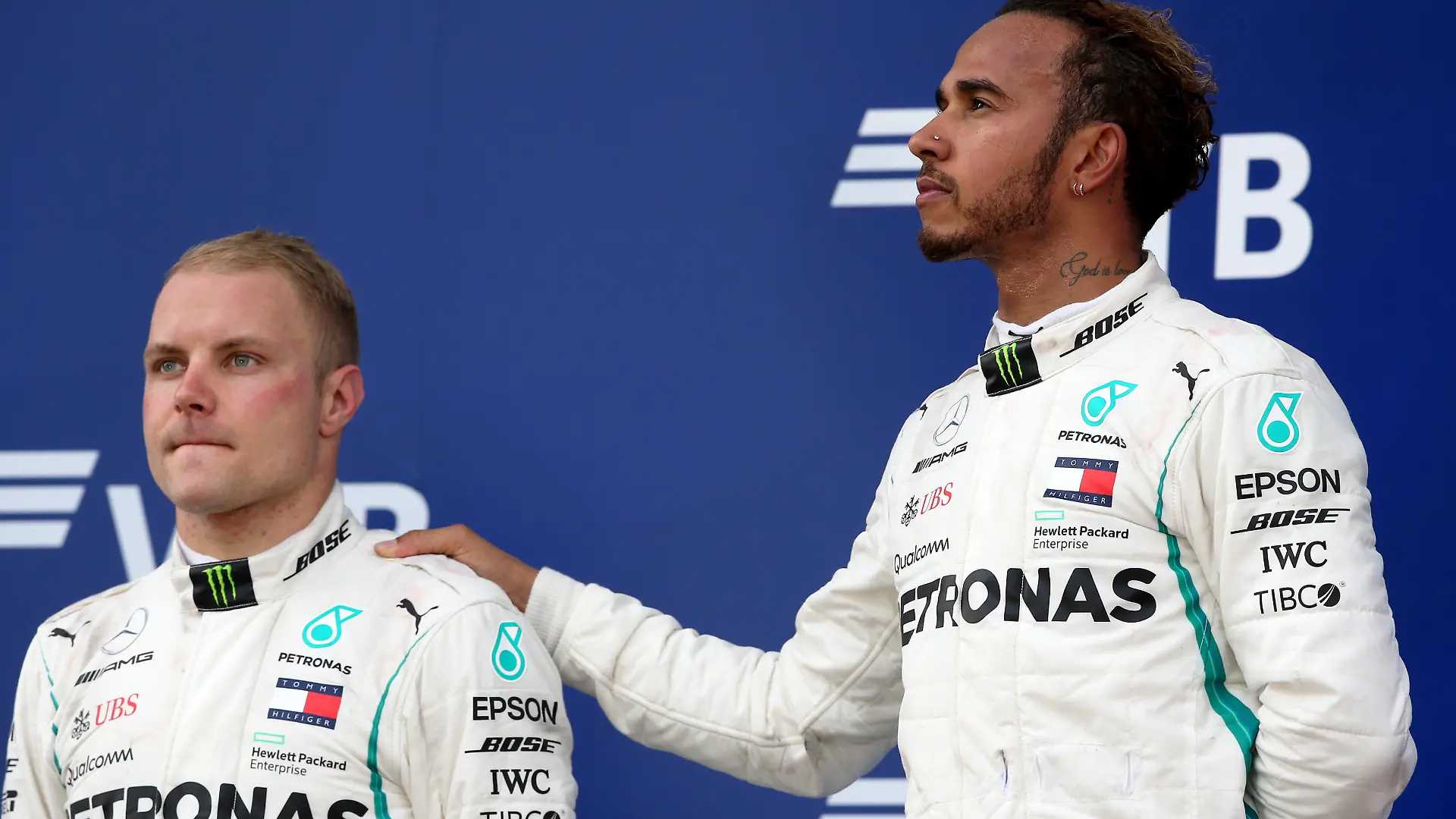 SOCHI, RUSSIA - SEPTEMBER 30:  Race winner Lewis Hamilton of Great Britain and Mercedes GP and second placed Valtteri Bottas of Finland and Mercedes GP look on, on the podium during the Formula One Grand Prix of Russia at Sochi Autodrom on September 30, 2018 in Sochi, Russia.  (Photo by Charles Coates/Getty Images)