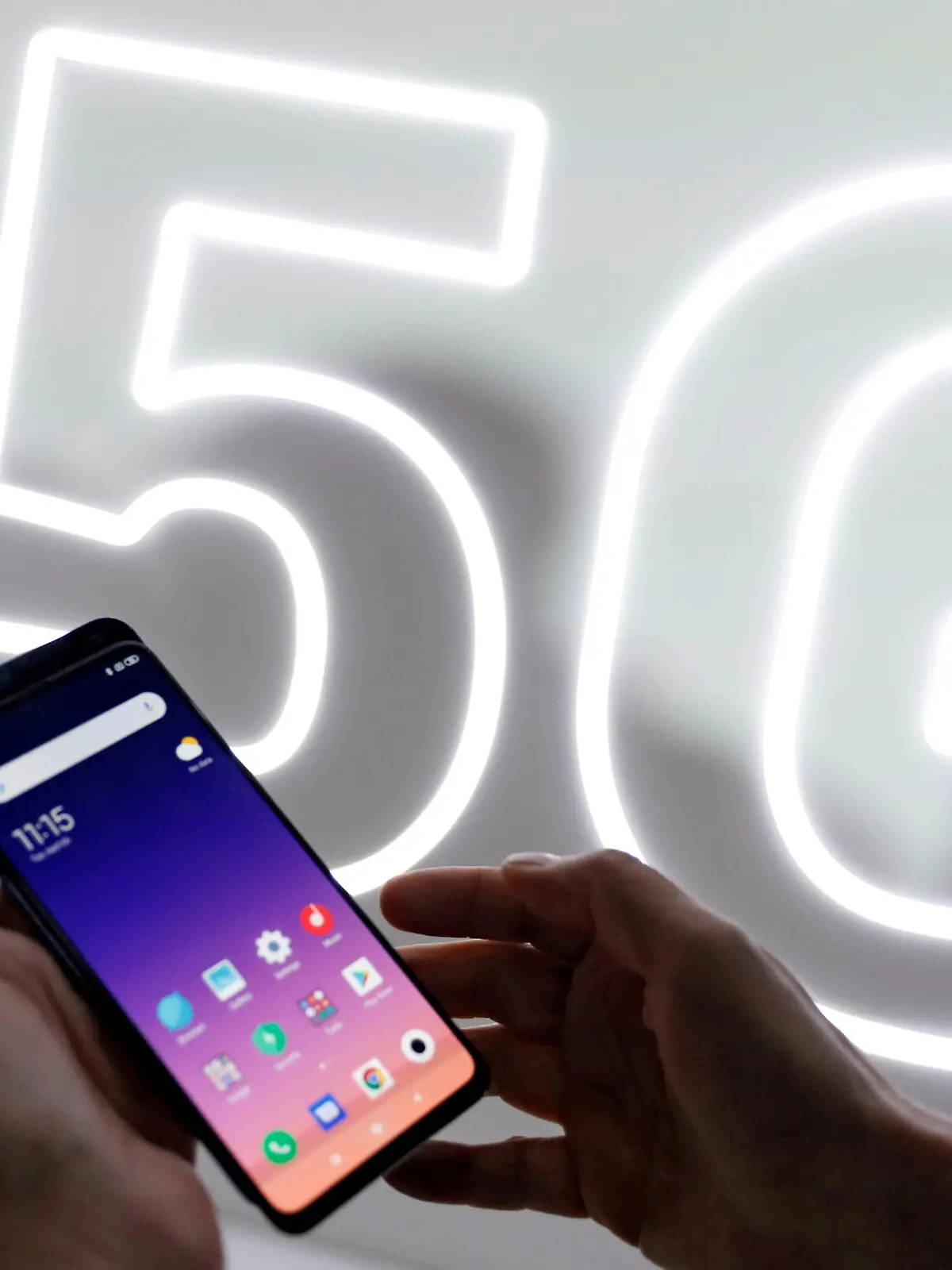 FILE PHOTO: FILE PHOTO: A person checks out the new Xiaomi Mi 9 mobile phone ahead of the Mobile World Congress (MWC 19) in Barcelona, Spain, February 24, 2019. REUTERS/Rafael Marchante/File Photo/File Photo