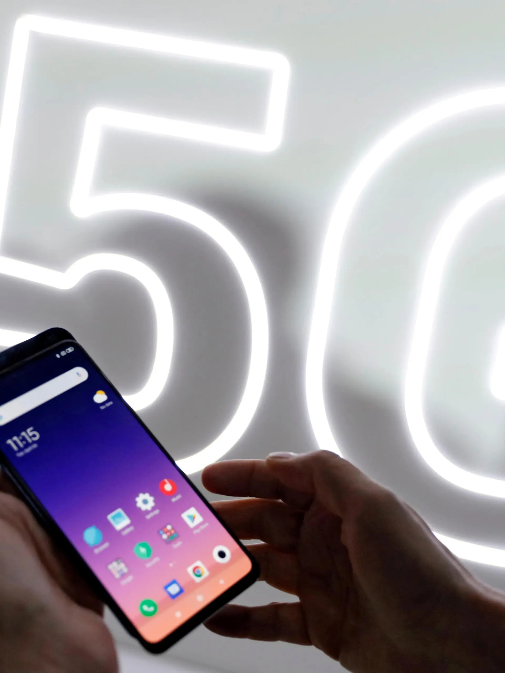 FILE PHOTO: FILE PHOTO: A person checks out the new Xiaomi Mi 9 mobile phone ahead of the Mobile World Congress (MWC 19) in Barcelona, Spain, February 24, 2019. REUTERS/Rafael Marchante/File Photo/File Photo