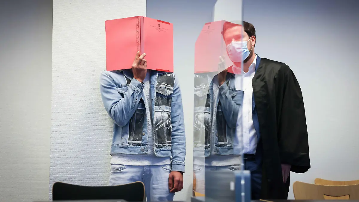 22.09.2021, Hamburg: Der Angeklagte steht zu Beginn des Prozesses neben seinem Anwalt Kilian Deery (r) im Gerichtssaal. Der 26-Jährige Angeklagte muss sich vor dem Amtsgericht Hamburg-St. Georg wegen gemeinschaftlichem Diebstahl verantworten. Unter anderem geht es um den Porsche des Sängers Udo Lindenberg, der am 22. Juni 2020 aus einer in Alsternähe gelegenen Hotel-Tiefgarage entwendet worden war. Foto: Christian Charisius/dpa/Pool/dpa +++ dpa-Bildfunk +++