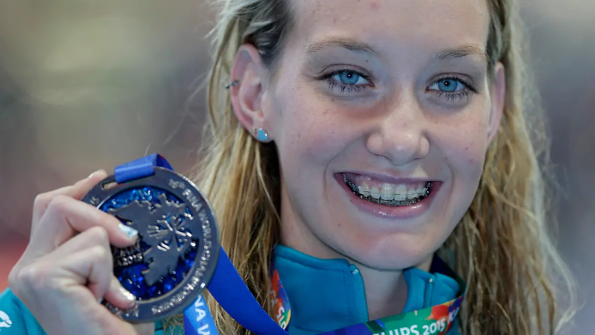 FILE - Australia's Madison Wilson holds her silver medal after her second place finish in the women's 100m backstroke final at the Swimming World Championships in Kazan, Russia, in this Tuesday, Aug. 4, 2015, file photo. Olympic gold medal swimmer Madison Wilson of Australia has been hospitalized for treatment of COVID-19. Wilson, who is fully vaccinated, was forced to withdraw from the International Swim League competition in Naples, Italy because of the diagnosis. “I’m taking some time to rest and I’m sure I’ll be ready to bounce back in no time,” Wilson said in a post Sunday, Sept. 19, 2021. (AP Photo/Michael Sohn, File)