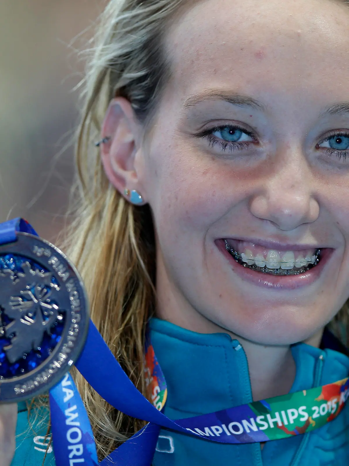 FILE - Australia's Madison Wilson holds her silver medal after her second place finish in the women's 100m backstroke final at the Swimming World Championships in Kazan, Russia, in this Tuesday, Aug. 4, 2015, file photo. Olympic gold medal swimmer Madison Wilson of Australia has been hospitalized for treatment of COVID-19. Wilson, who is fully vaccinated, was forced to withdraw from the International Swim League competition in Naples, Italy because of the diagnosis. “I’m taking some time to rest and I’m sure I’ll be ready to bounce back in no time,” Wilson said in a post Sunday, Sept. 19, 2021. (AP Photo/Michael Sohn, File)