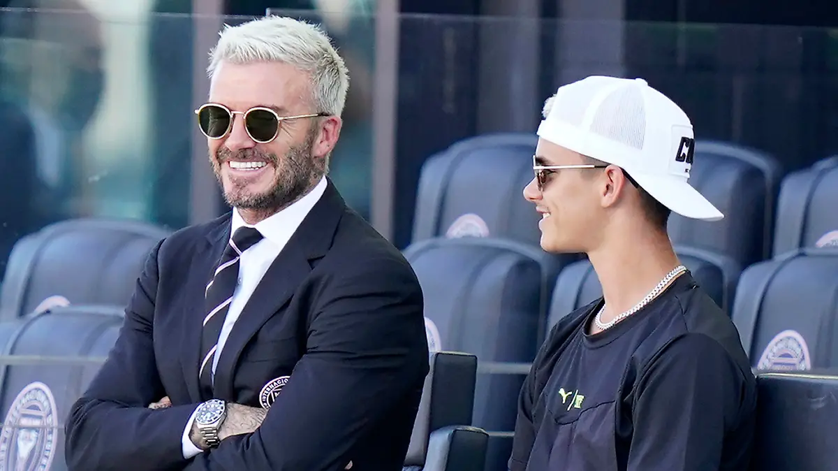 David Beckham, owner and president of soccer operations for Inter Miami, watches from the stands with his son Romeo before an MLS soccer match against Nashville, Sunday, Aug. 8, 2021, in Fort Lauderdale, Fla. (AP Photo/Lynne Sladky)