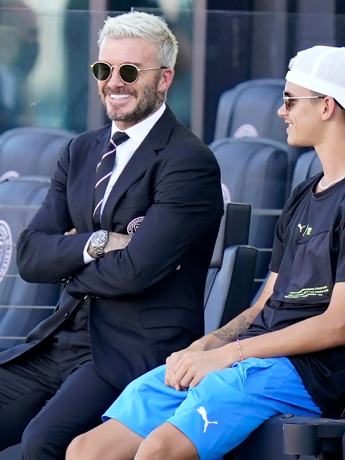 David Beckham, owner and president of soccer operations for Inter Miami, watches from the stands with his son Romeo before an MLS soccer match against Nashville, Sunday, Aug. 8, 2021, in Fort Lauderdale, Fla. (AP Photo/Lynne Sladky)