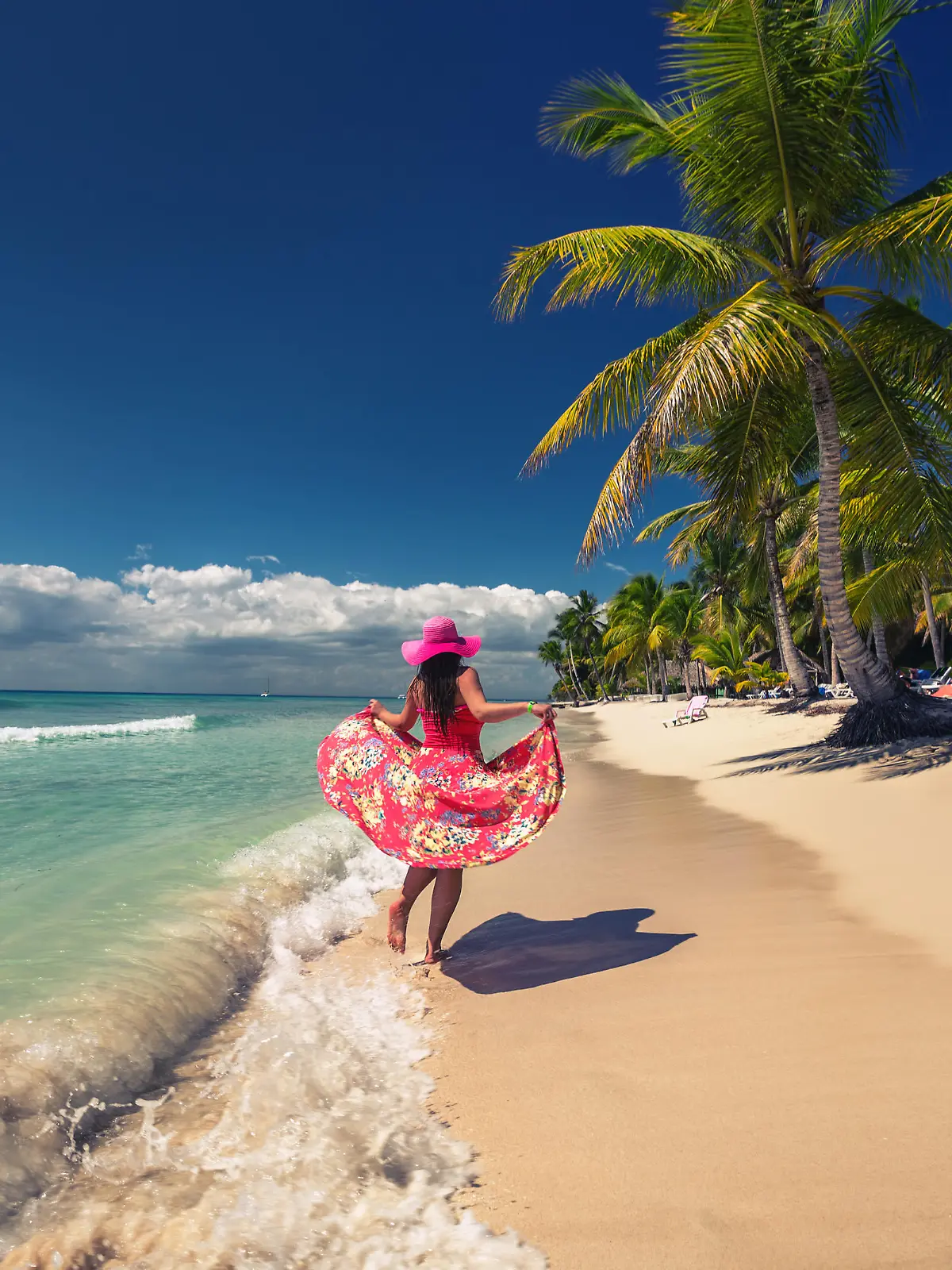 Carefree young woman  walking on the tropical sandy beach, Saona island, Dominican Republic