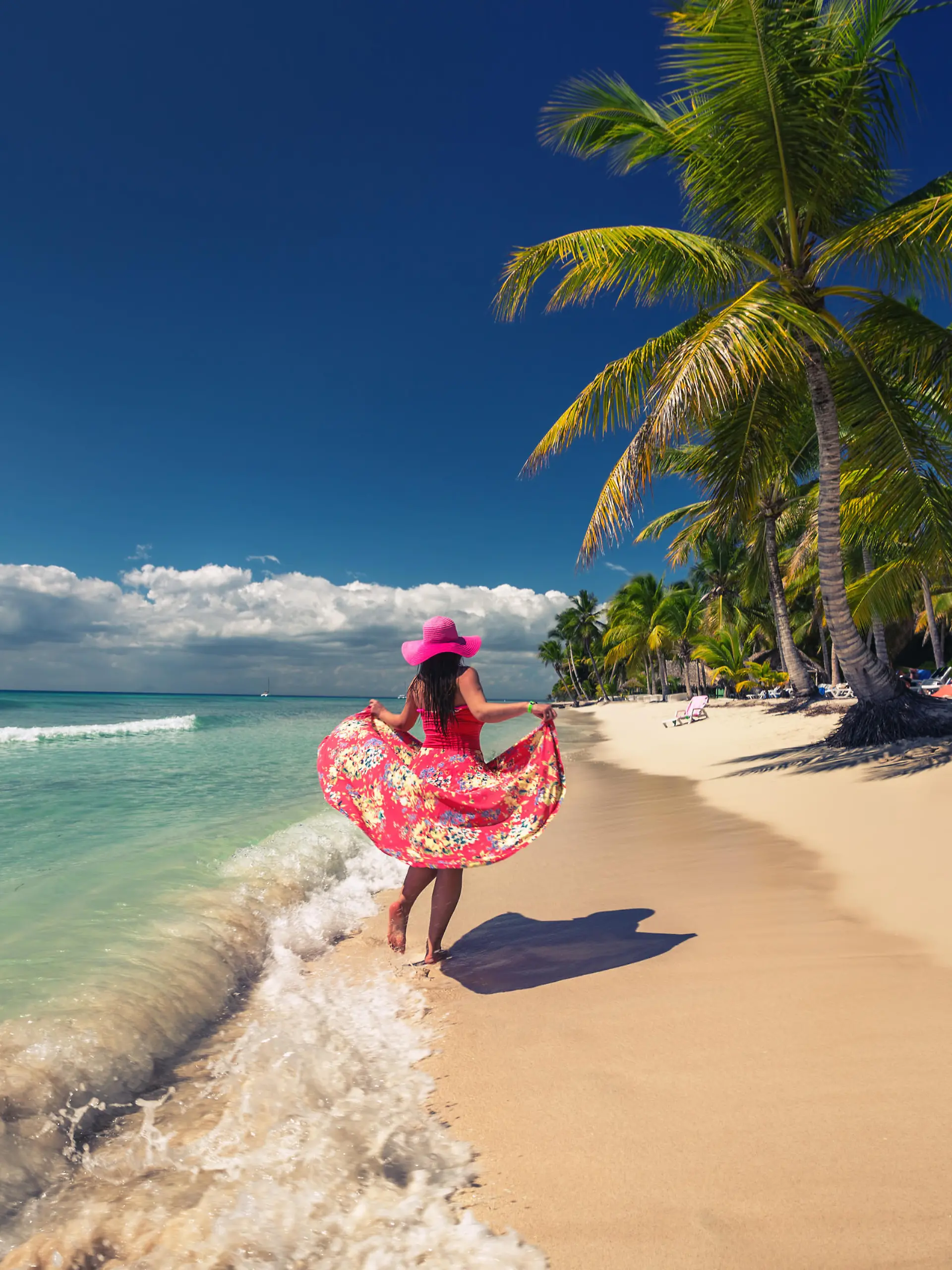 Carefree young woman  walking on the tropical sandy beach, Saona island, Dominican Republic